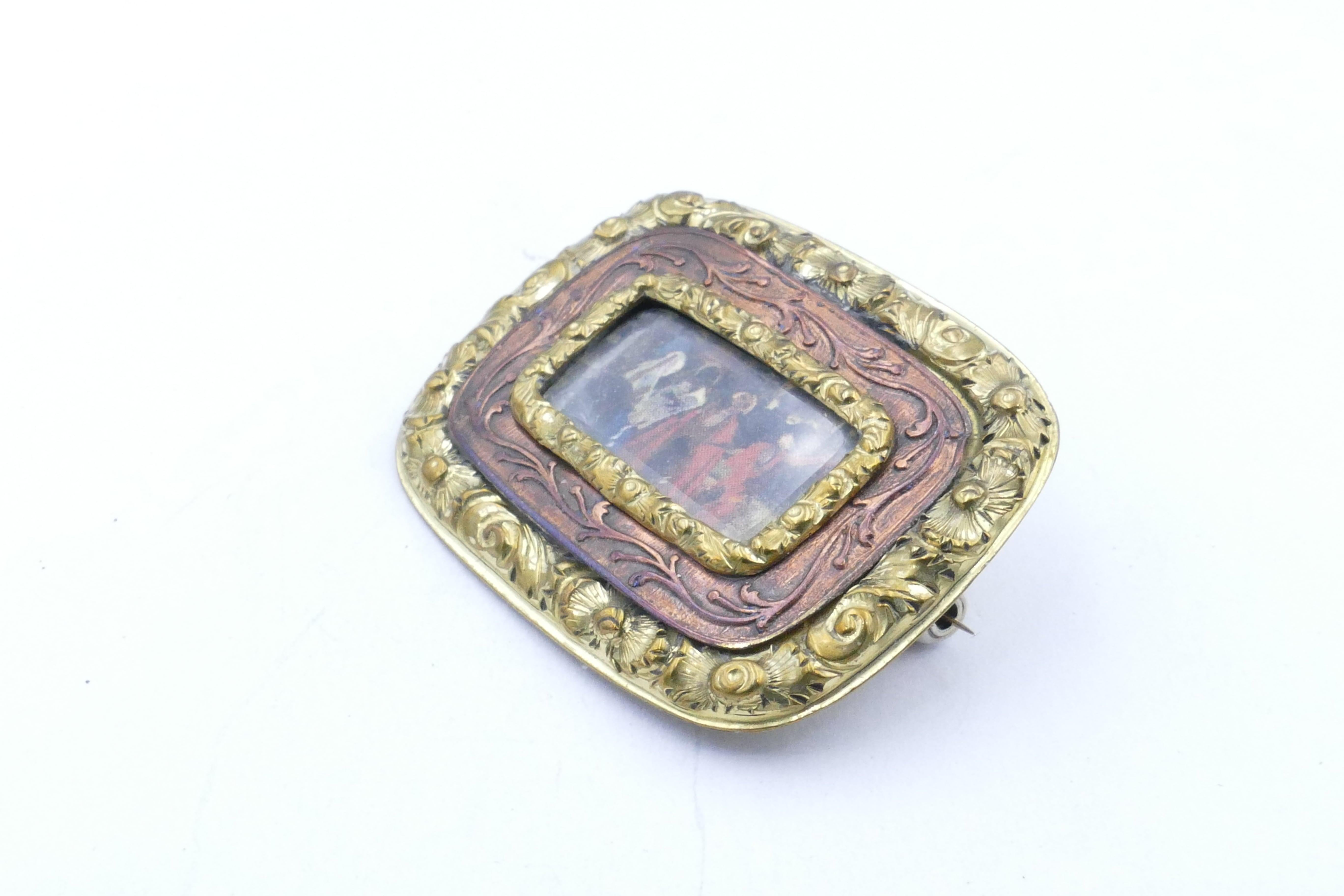 A great Find was this 1840's - 1860's Portrait Brooch.
Fashioned from 15ct Yellow Gold with Copper as well its centre is a miniature portrait scene with the Yellow Gold Border having embossed filigree, foliate & scrolling motifs.
The rear of the