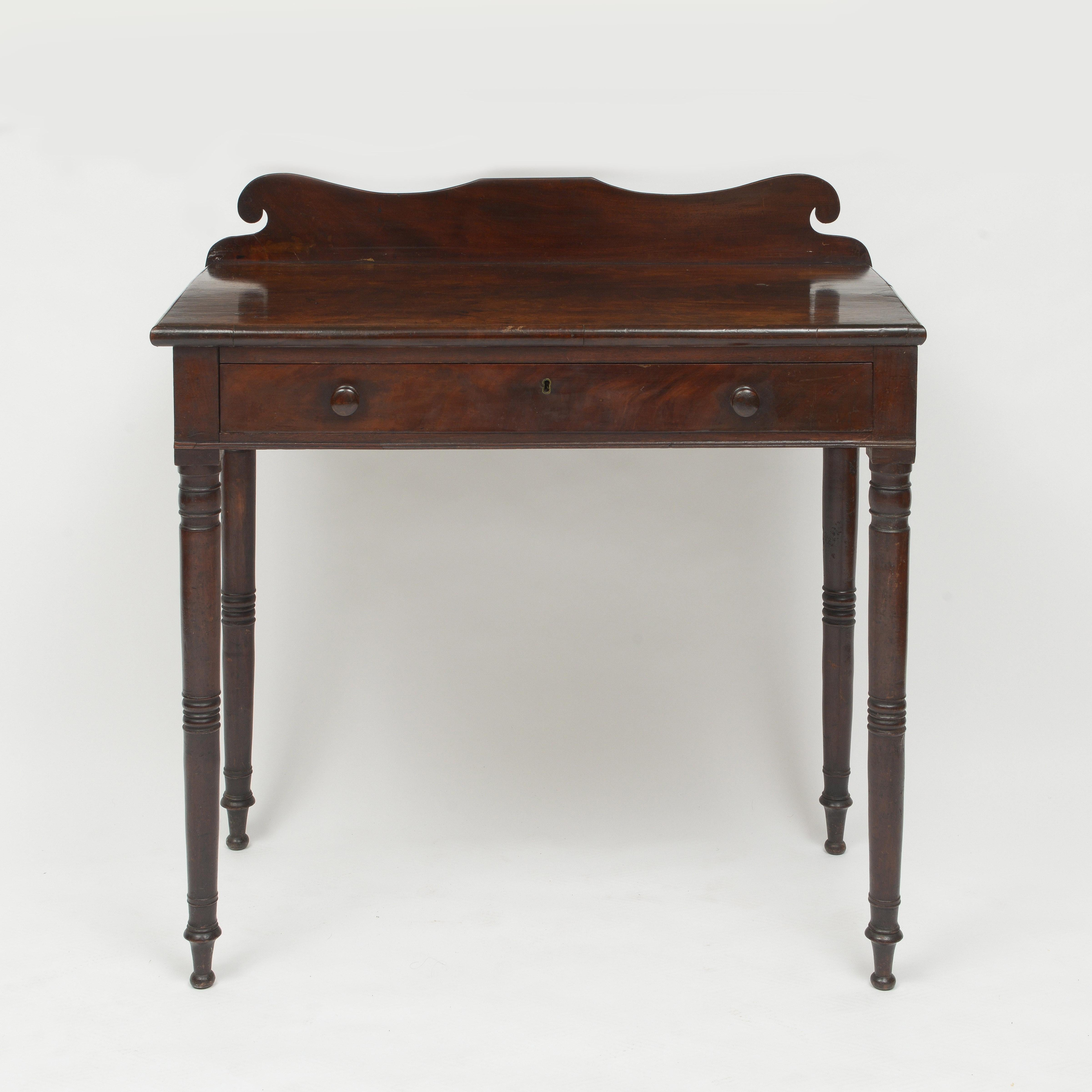 American figured walnut console table with single drawer and carved back on turned legs
