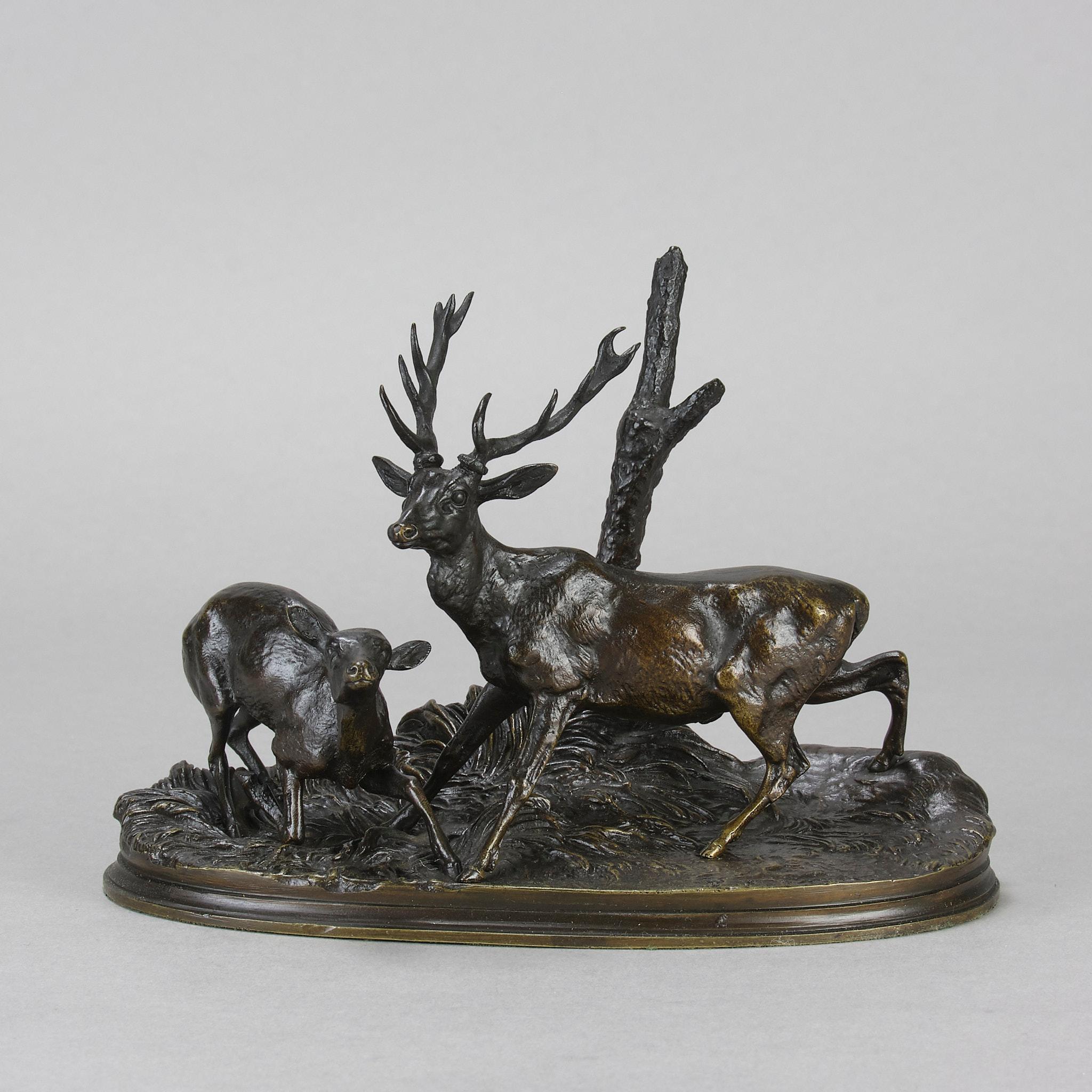 Excelente grupo de bronce animalier francés de mediados del siglo XIX de un ciervo y una cierva en un paisaje boscoso que exhibe un excelente detalle superficial acabado a mano y una rica pátina marrón, elevado sobre una base integral y firmado  P J