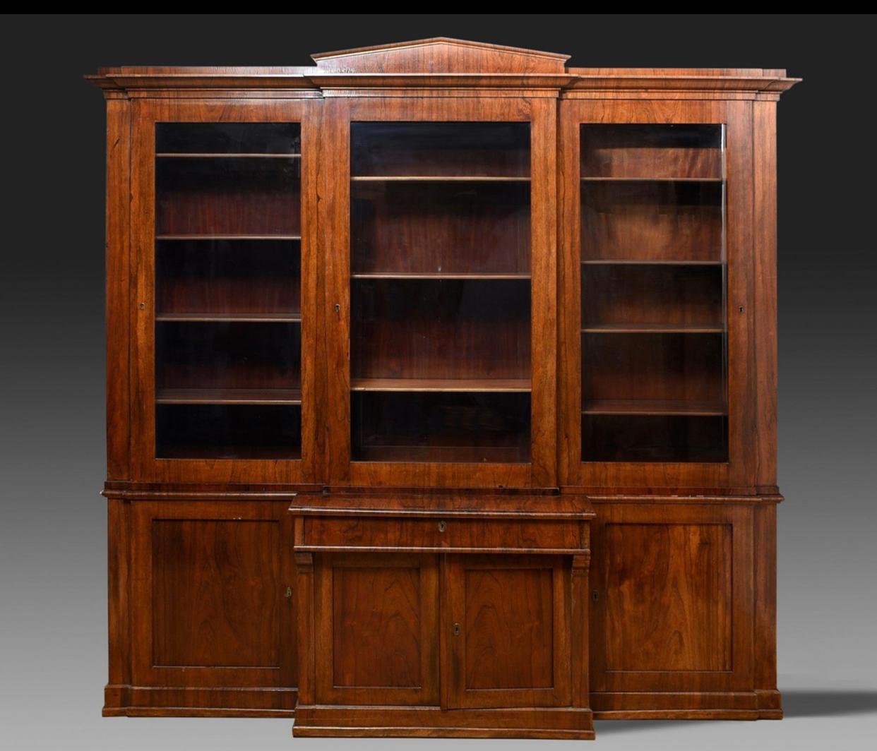 Mid-19th Century Bookcase
Northern Germany, Ca.1830

Library, Northern Germany 1830 Classic bookcase with a front under a pointed top and three glass sliding doors in the upper part and a drawer and a door in the lower part, northern German, circa