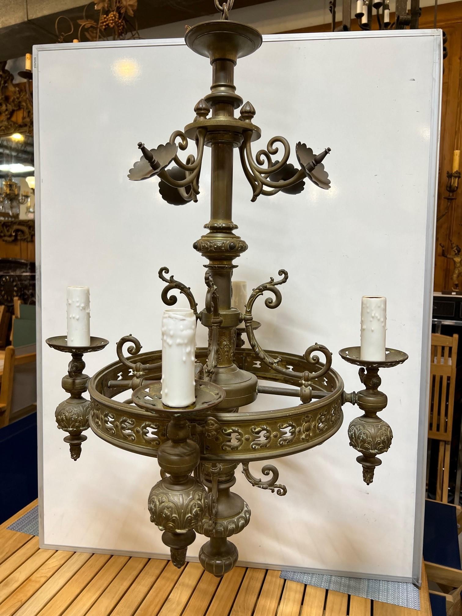 Mid-19th century antique gas four arm bronze chandelier which has been recently electrified circa 1860. This is a nice converted gas chandelier with a lot of bronze filigree and beautiful details. It has four arms each with a gas knob which was used