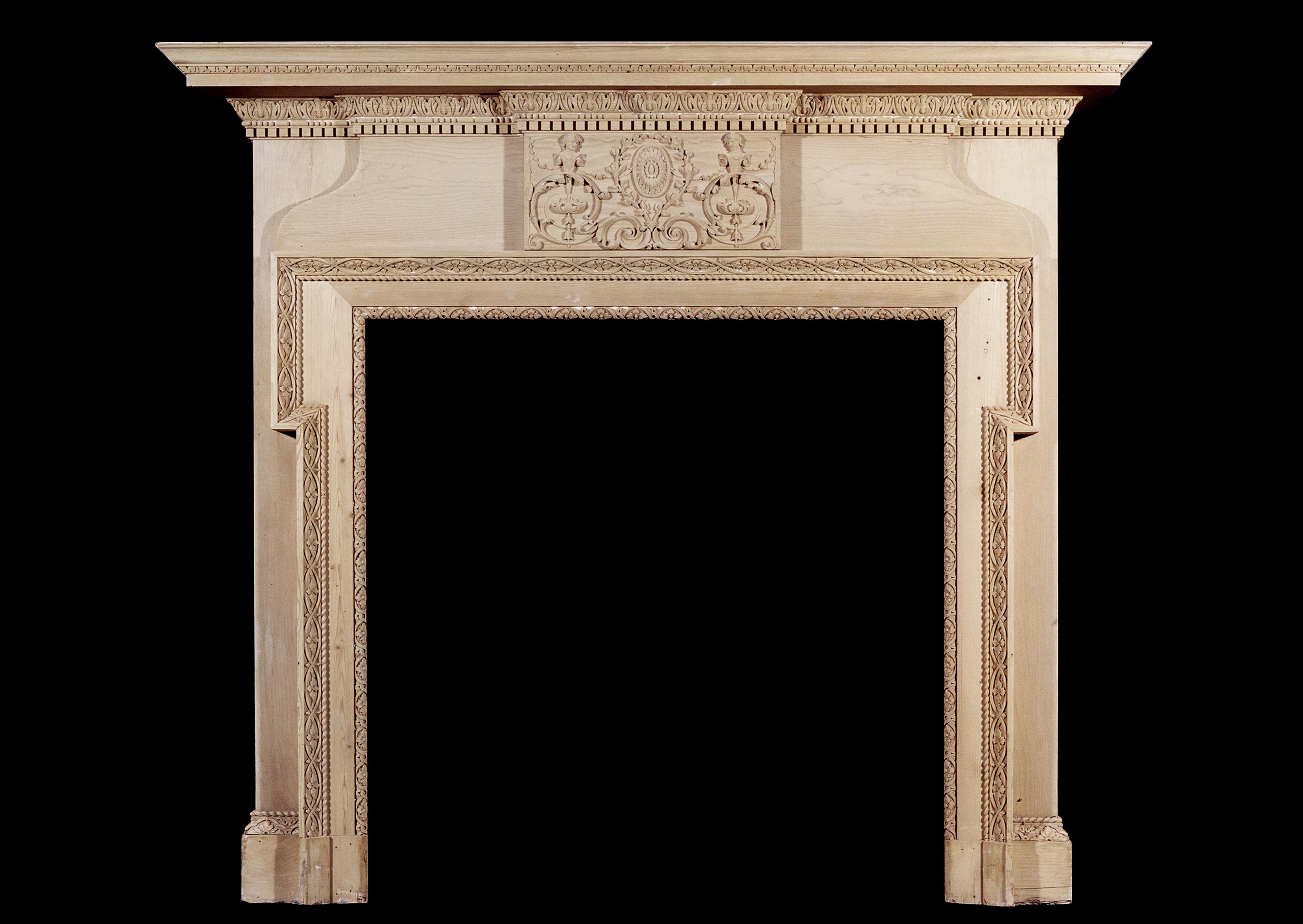 A mid-19th century English carved pine fireplace, with carved leaf and dentils to cornice, carved patera and foliage to centre frieze and leaf and rope twist around inner mouldings.

Shelf Width:	1725 mm      	67 7/8 in
Overall Height:	1520 mm     