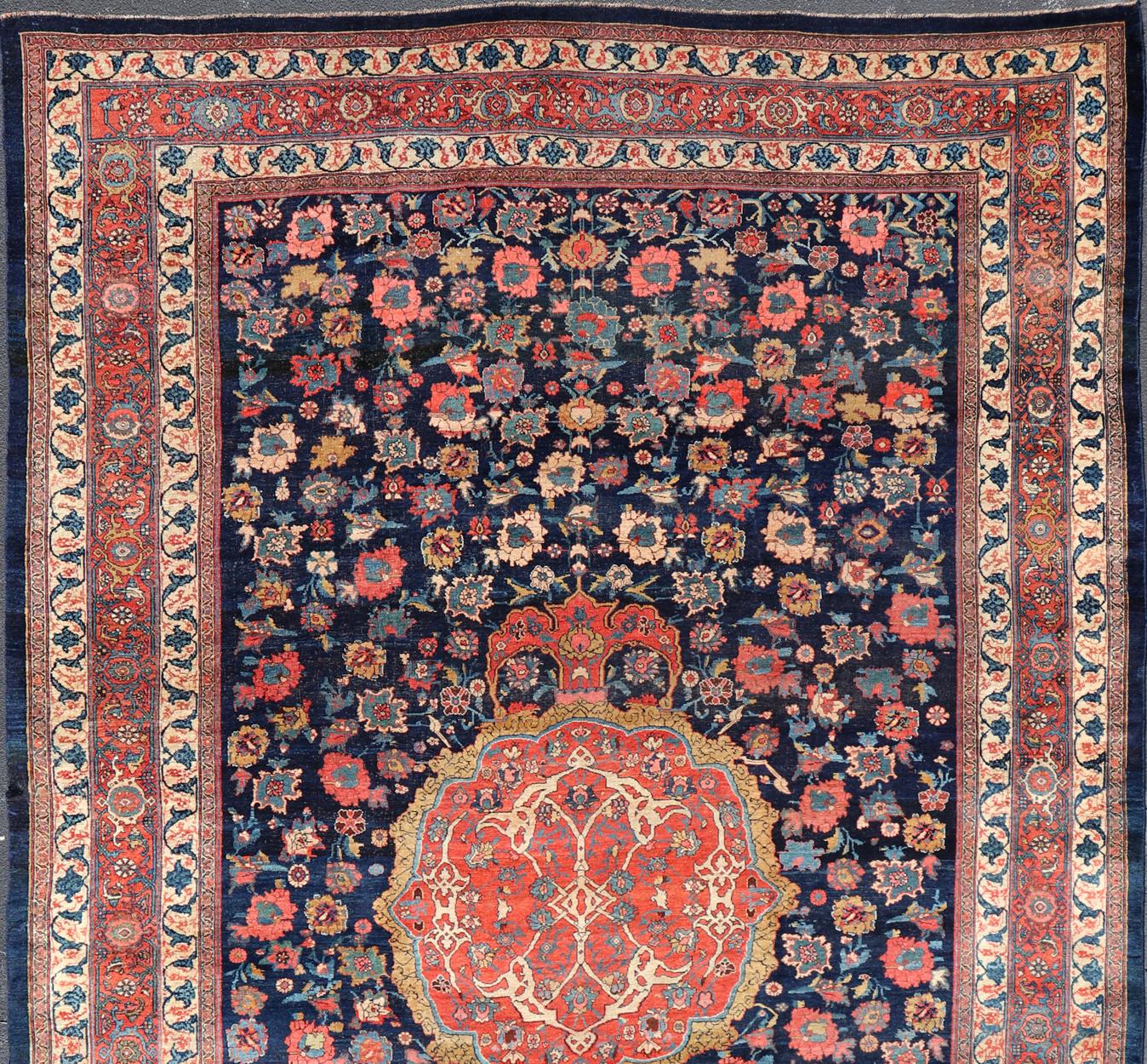 Colorful antique Persian large Bidjar rug with central medallion and all over rose and flower pattern. set on a navy blue background, rug R20-0803, country of origin / type: Iran / Bidjar, late 19th century

This beautiful large antique Bidjar rug