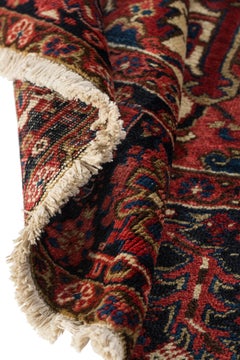 Early 20th Century Antique Persian Heriz hand knotted carpet with rich red color