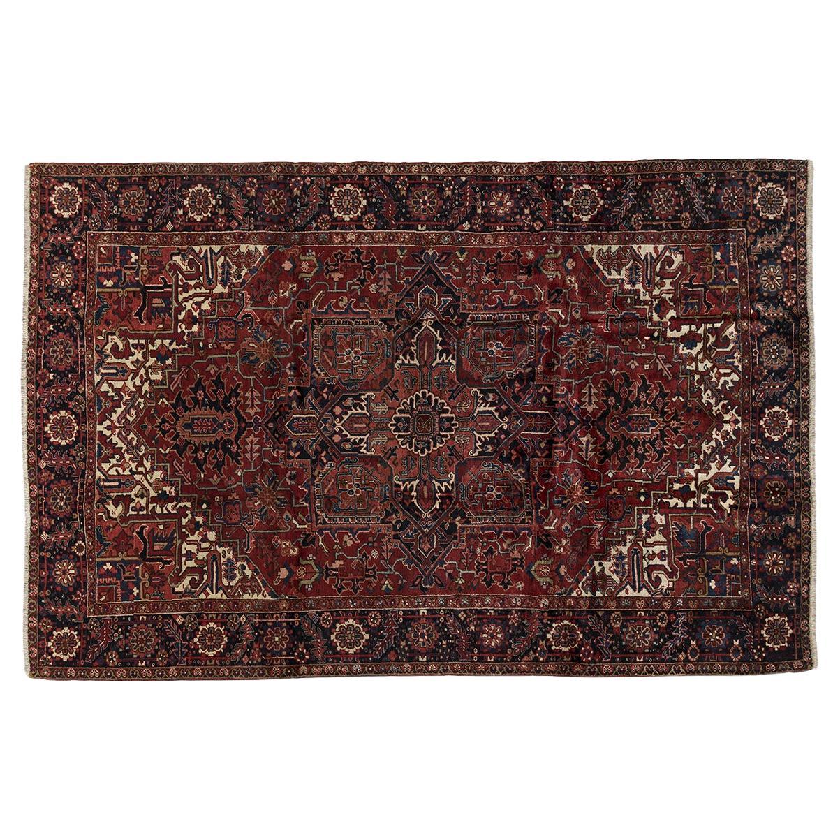 Mid 19th Century Antique Persian Heriz hand knotted carpet with rich red colors For Sale