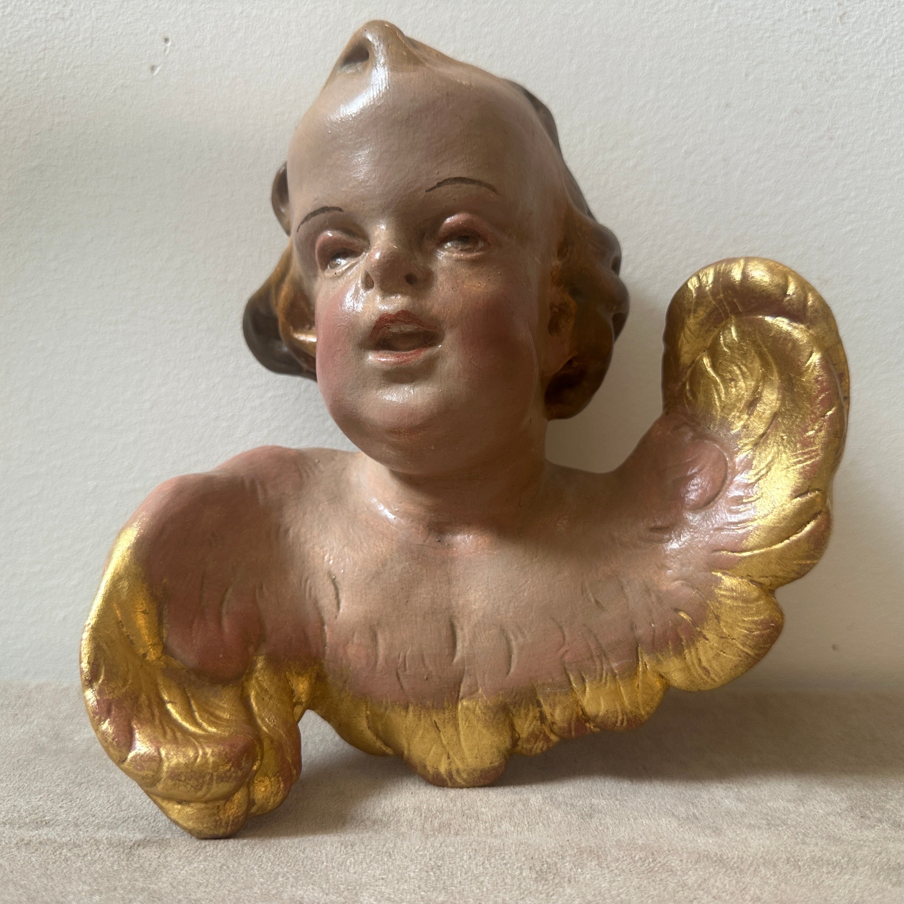 This ceramic angel is a captivating piece of art, reflecting the ornate and dramatic characteristics typical of the Baroque period. The piece exudes a sense of opulence and drama, characteristic of the Baroque style that flourished in the 17th