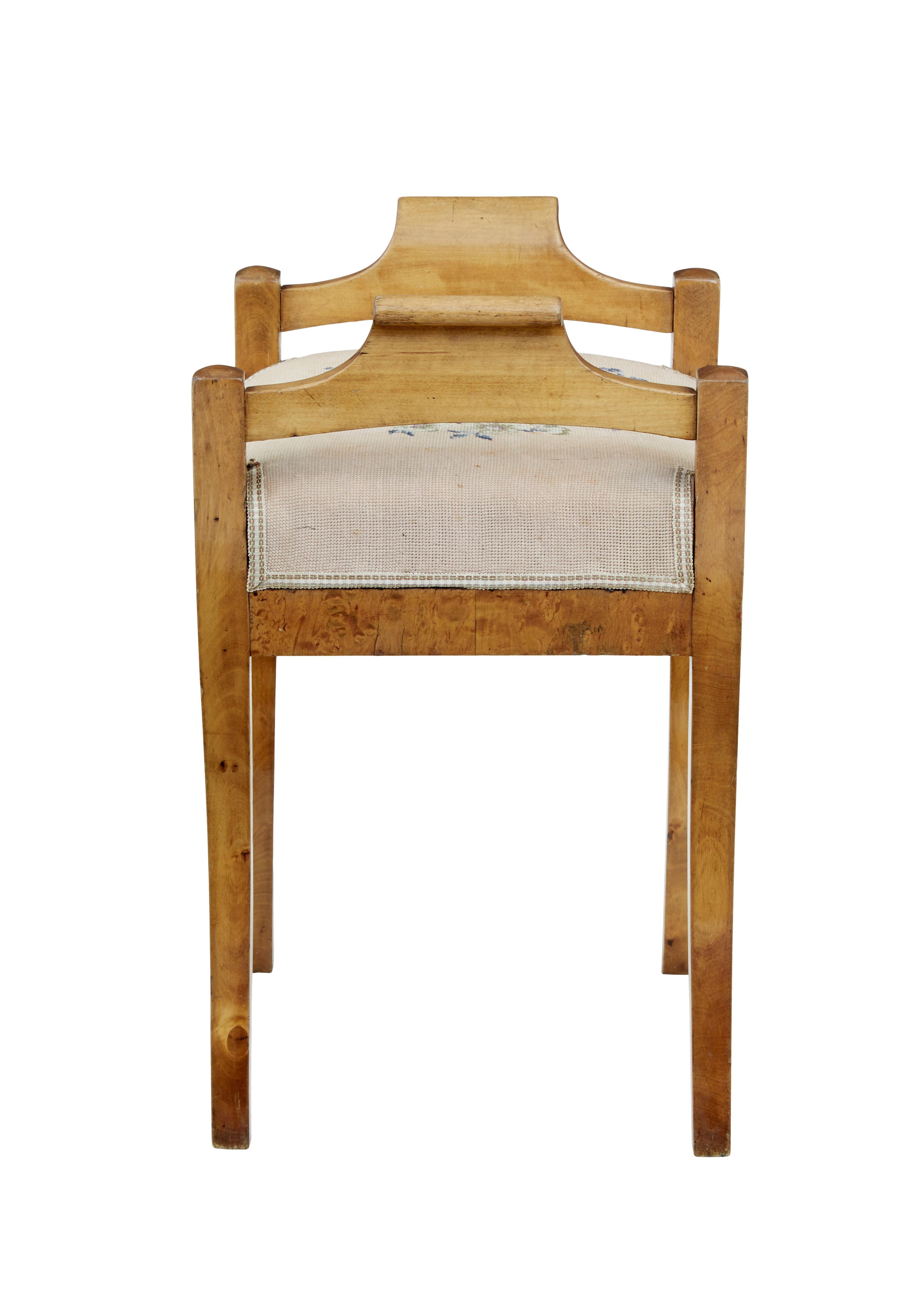 Mid-19th century birch Empire stool, circa 1850.

Scandinavian Empire period stool made in birch. Shaped support handles which flow through to the 4 splayed legs. Original floral tapestry seat covering.

Minor losses to woodwork, expected fading