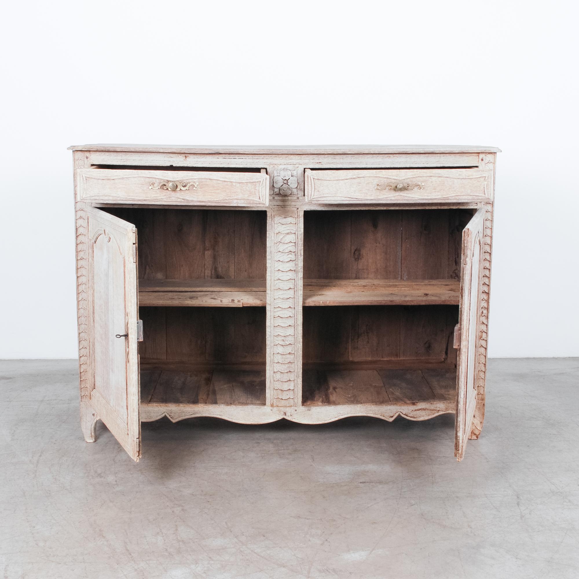 Beautiful functional buffet with floral details. Natural bleached oak finish, constructed to last with old-world expertise, original brass hardware, interior shelf and oak pins. Attractive wooden joinery looks great from every angle.
