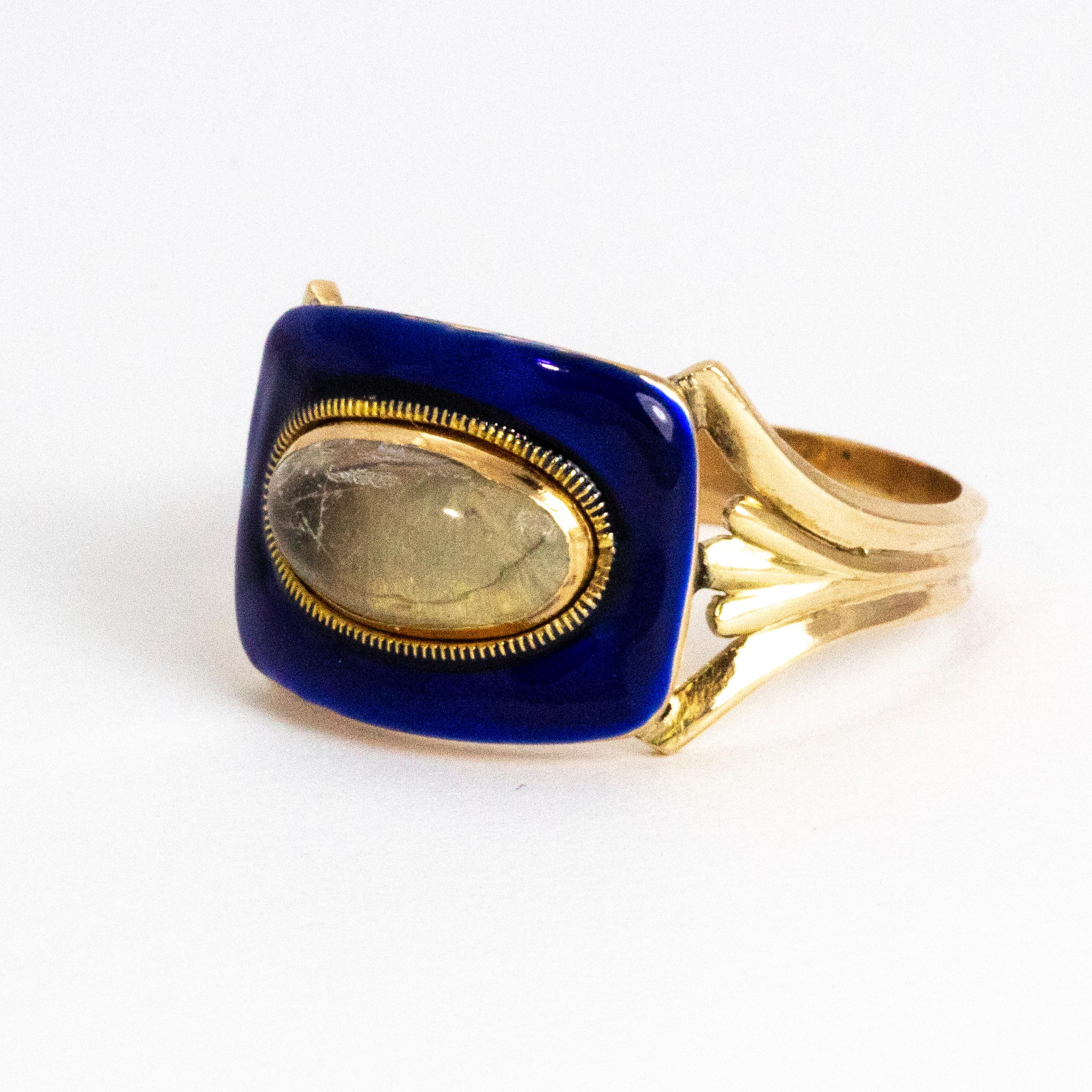 Striking blue enamel surrounding a glossy cabochon crystal. This Victorian beauty is modelled out of gold and has initials reading E.A. engraved underneath the main panel. 

Ring Size: T or 9 1/2 
Face Dimensions: 12mm x 15.5mm 
