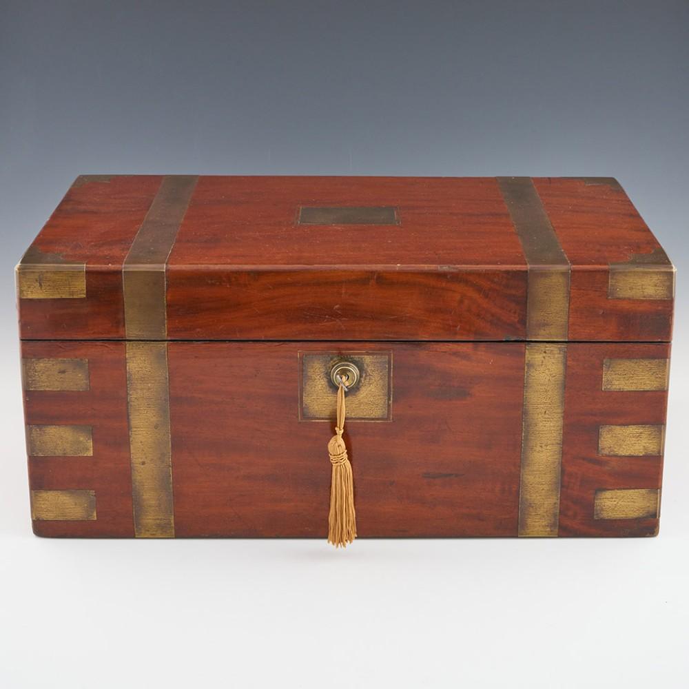 Heading : Mid 19th centurt brass bound writing box
Date : c1850
Period : Victorian
Origin : England
Decoration : Brass bound mahogany with central vacant brass cartouche. Internally leather lined slope with two hinged cavaties below slope (one with