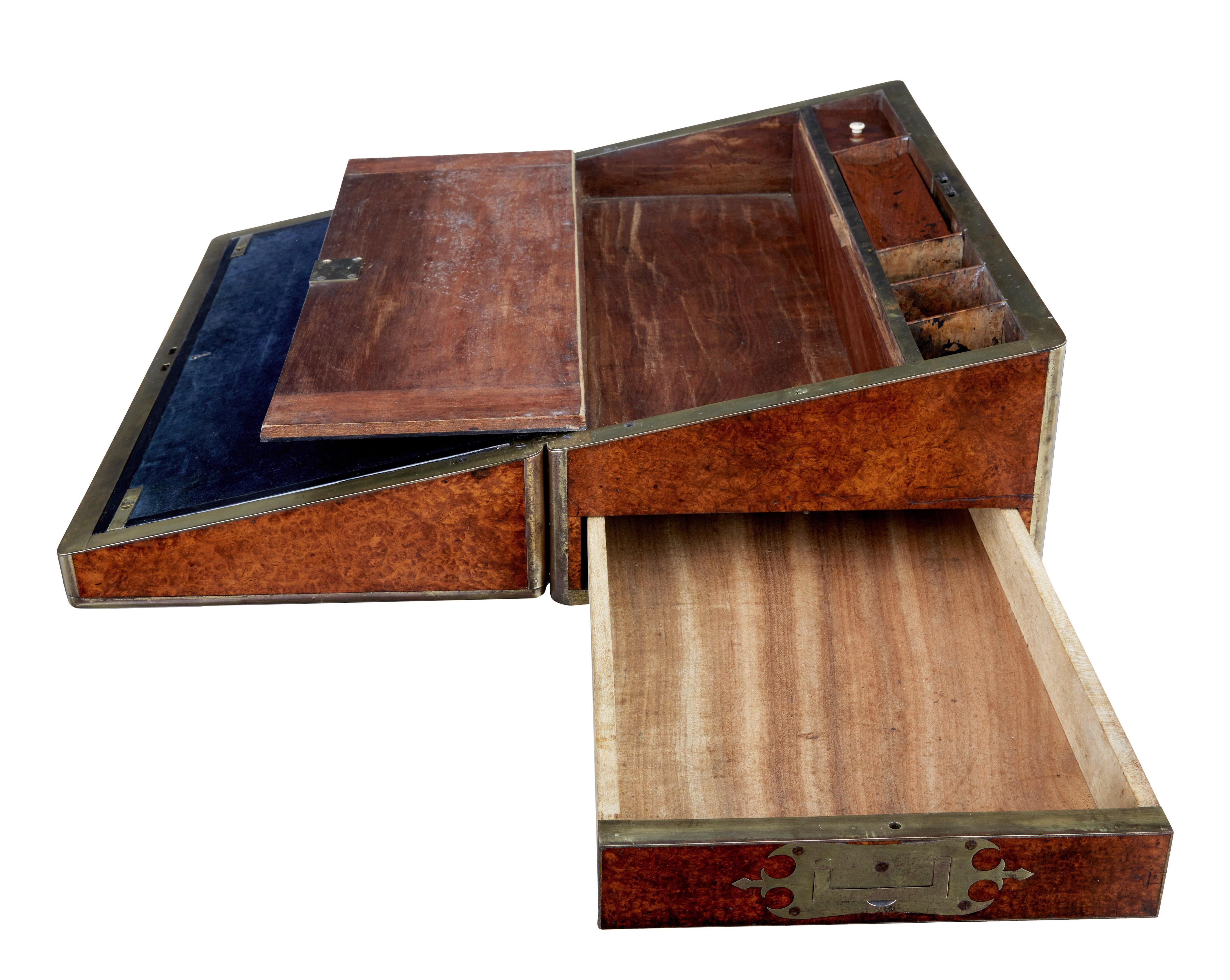 Mid 19th century burr campaign lap desk circa 1860.

Good quality burr writing box.

Beautifully brass bound outside and inside edging. Stunning burr wood exterior. Original dark blue velvet writing surface which splits both ways to reveal storage.