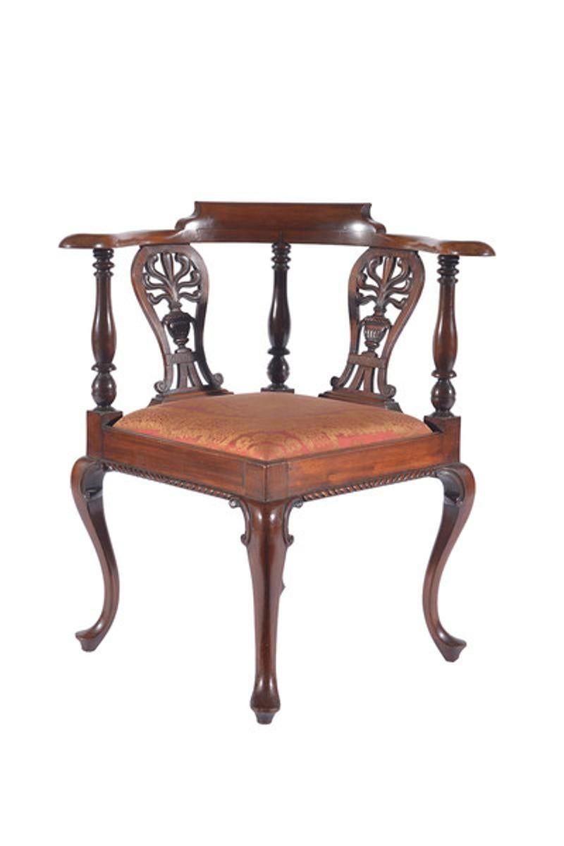 A fine mid-19th century carved mahogany corner chair.
The back with a shaped top rail on three turned supports and with a pierced and carved splat to each side with a drop-in seat below.
The whole raised on four carved cabriole legs.
The drop-in