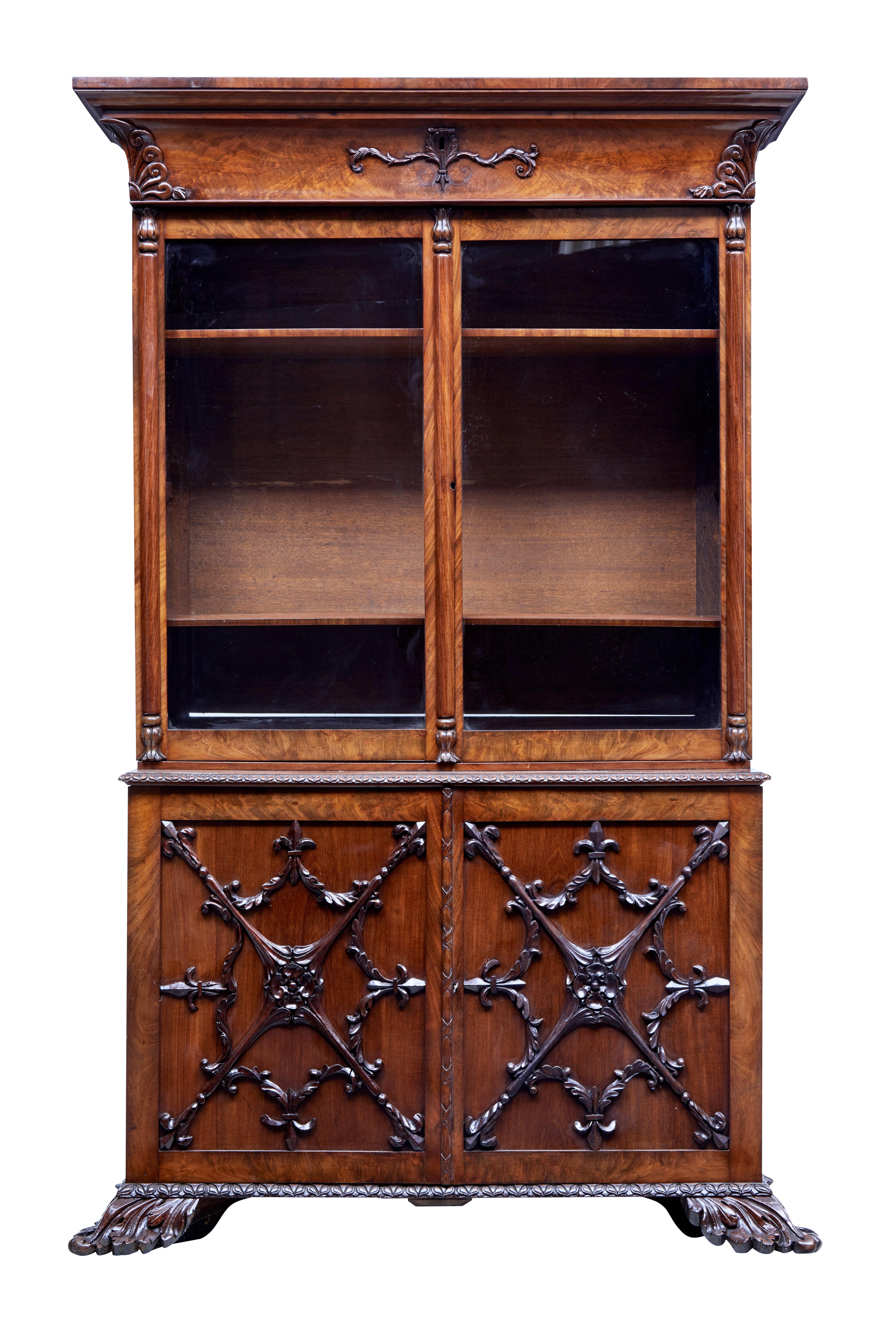 Rare danish carved mahogany bookcase, circa 1840.

2 part bookcase. Top section with hidden drawer below the cornice. Applied carving to corners and around the key hole. Double glazed doors open to 2 shelves with fixed height brackets for a