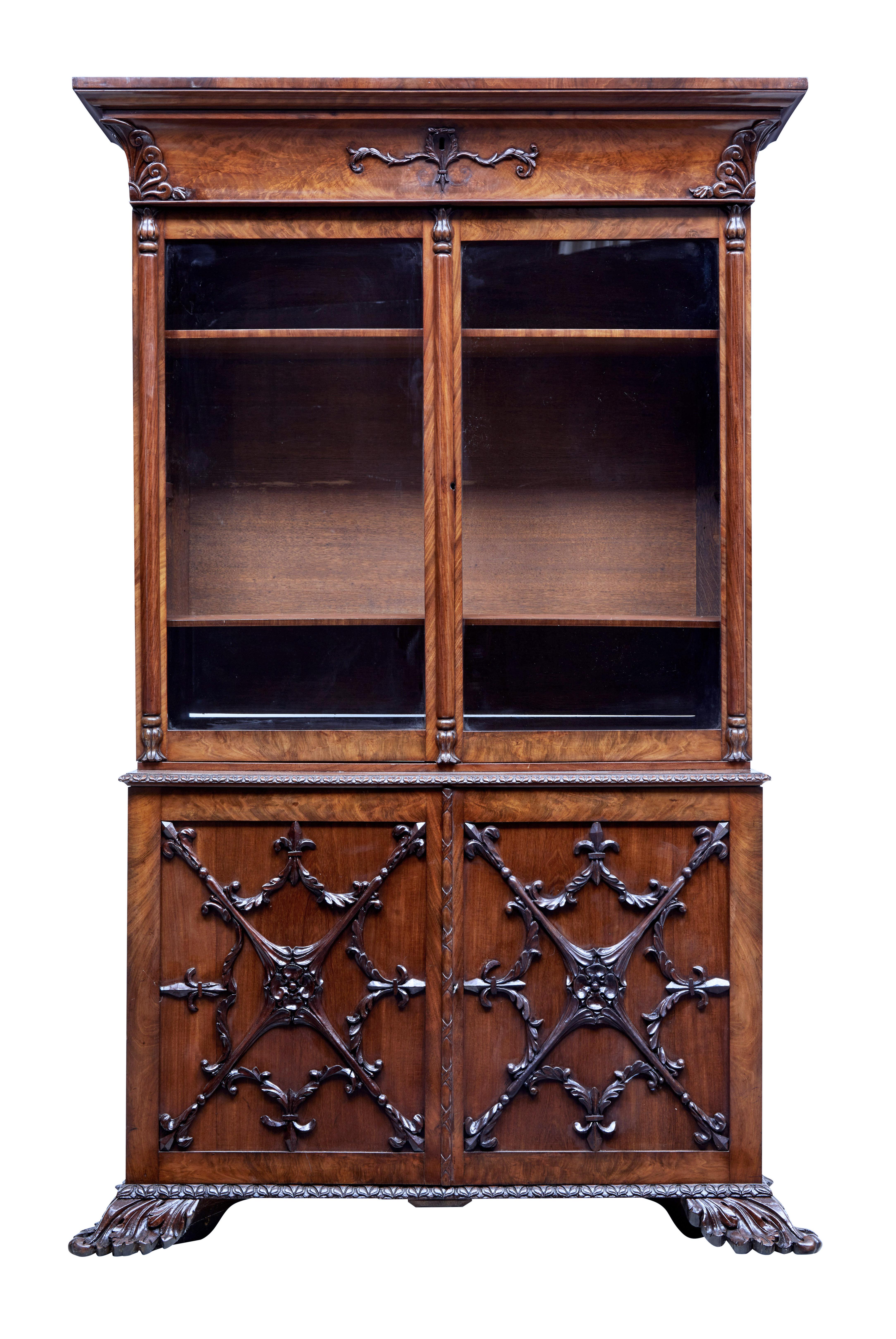 Rare danish carved mahogany bookcase circa 1840.

2 part bookcase.  Top section with hidden drawer below the cornice.  Applied carving to corners and around the key hole.  Double glazed doors open to 2 shelves with fixed height brackets for a