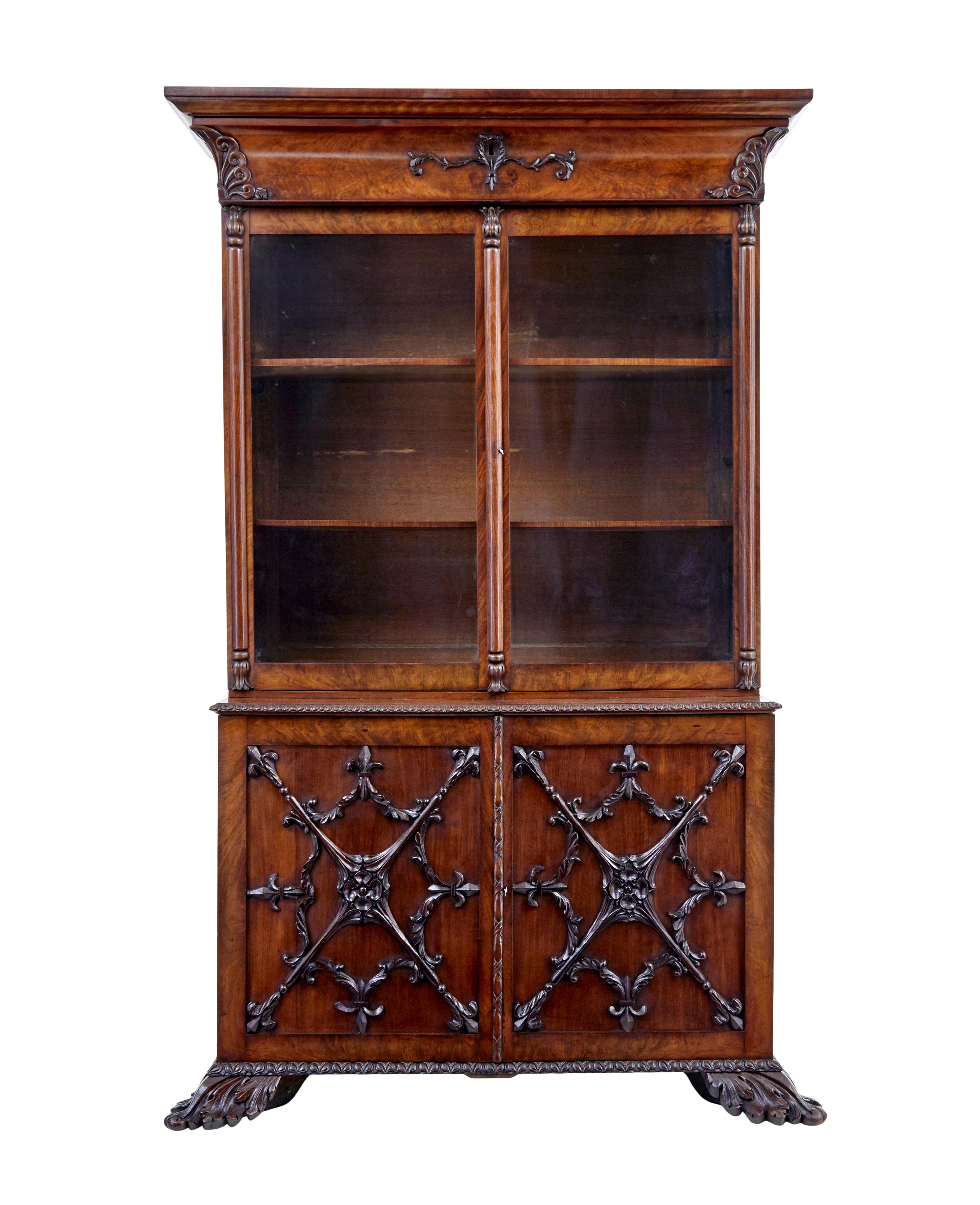 Rare danish carved mahogany bookcase circa 1840.

2 part bookcase.  Top section with hidden drawer below the cornice.  Applied carving to corners and around the key hole.  Double glazed doors open to 2 shelves with fixed height brackets for a