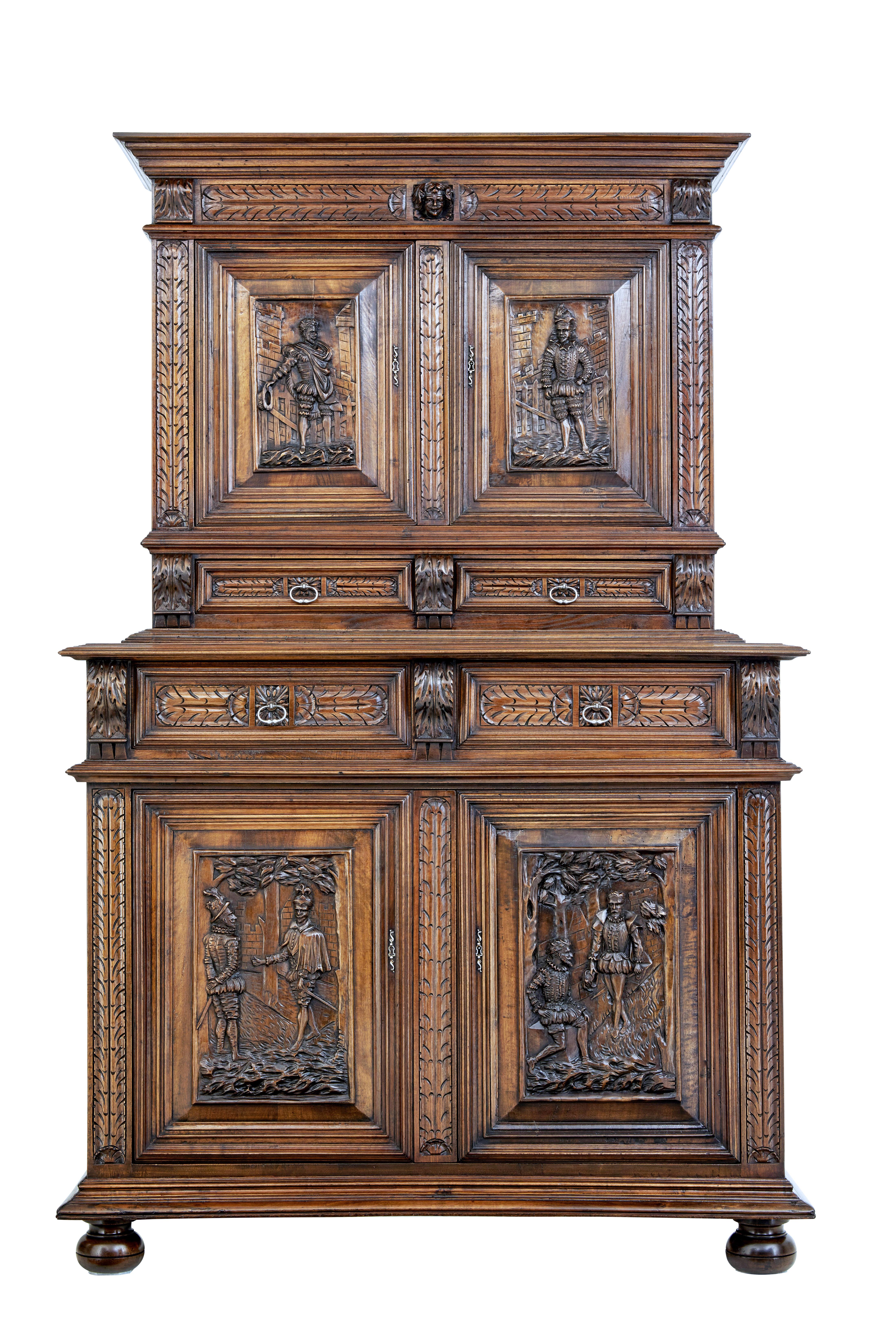 Good quality carved Italian two part cabinet cupboard, circa 1850.

Beautifully carved in walnut, with good colour and patina.

Features four carved panels on the doors of Spanish gentlemen in 16th century dress, further carved decoration with