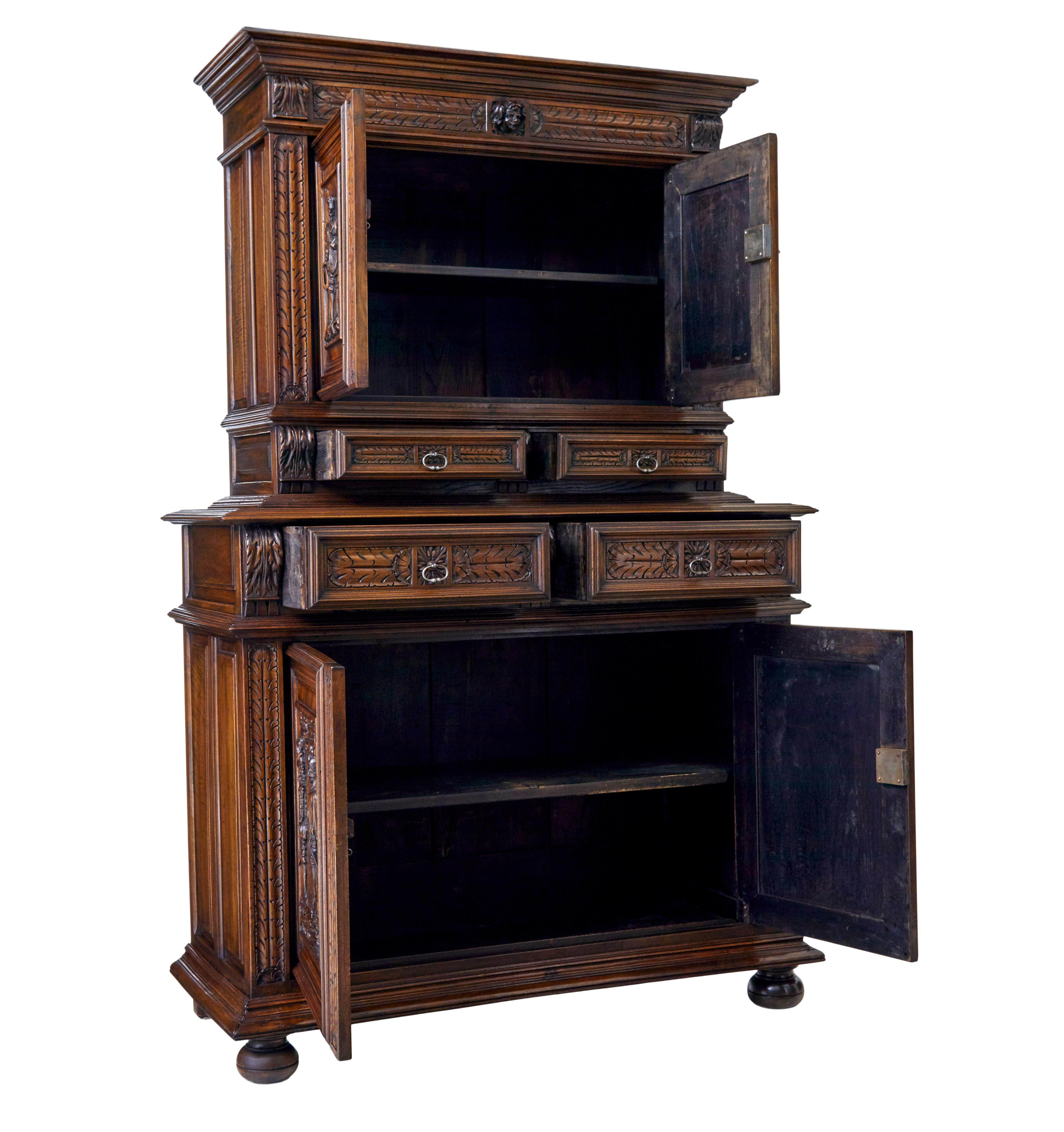 Good quality carved Italian two part cabinet cupboard, circa 1850.

Beautifully carved in walnut, with good colour and patina.

Features four carved panels on the doors of Spanish gentlemen in 16th century dress, further carved decoration with