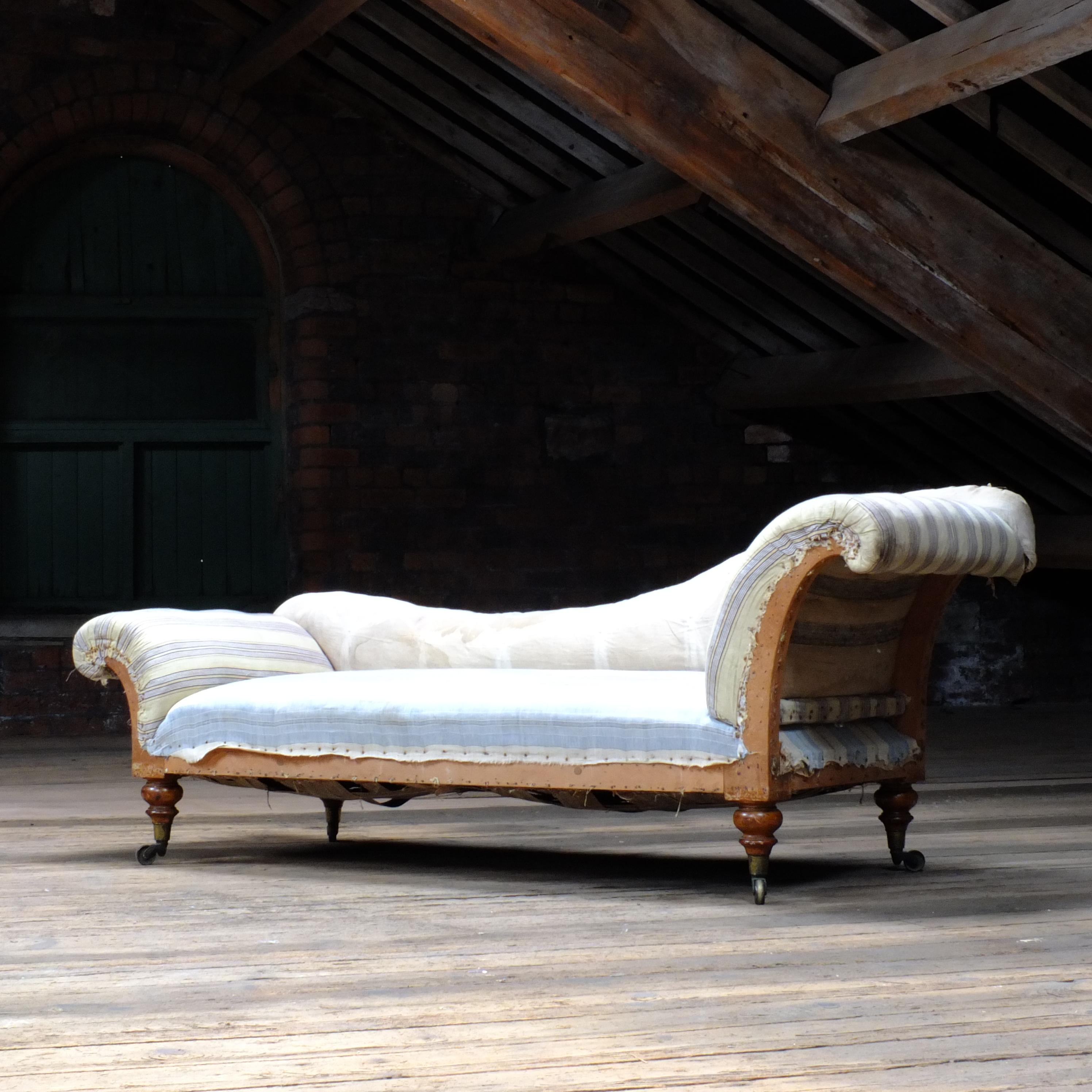 A superb quality Victorian chaise lounge by Charles Hindley & sons of 134 oxford street London. Raised on 4 chunky turned legs with the original brass cup castors. 
The build quality of this piece is reminiscent to that of Howard and son and in