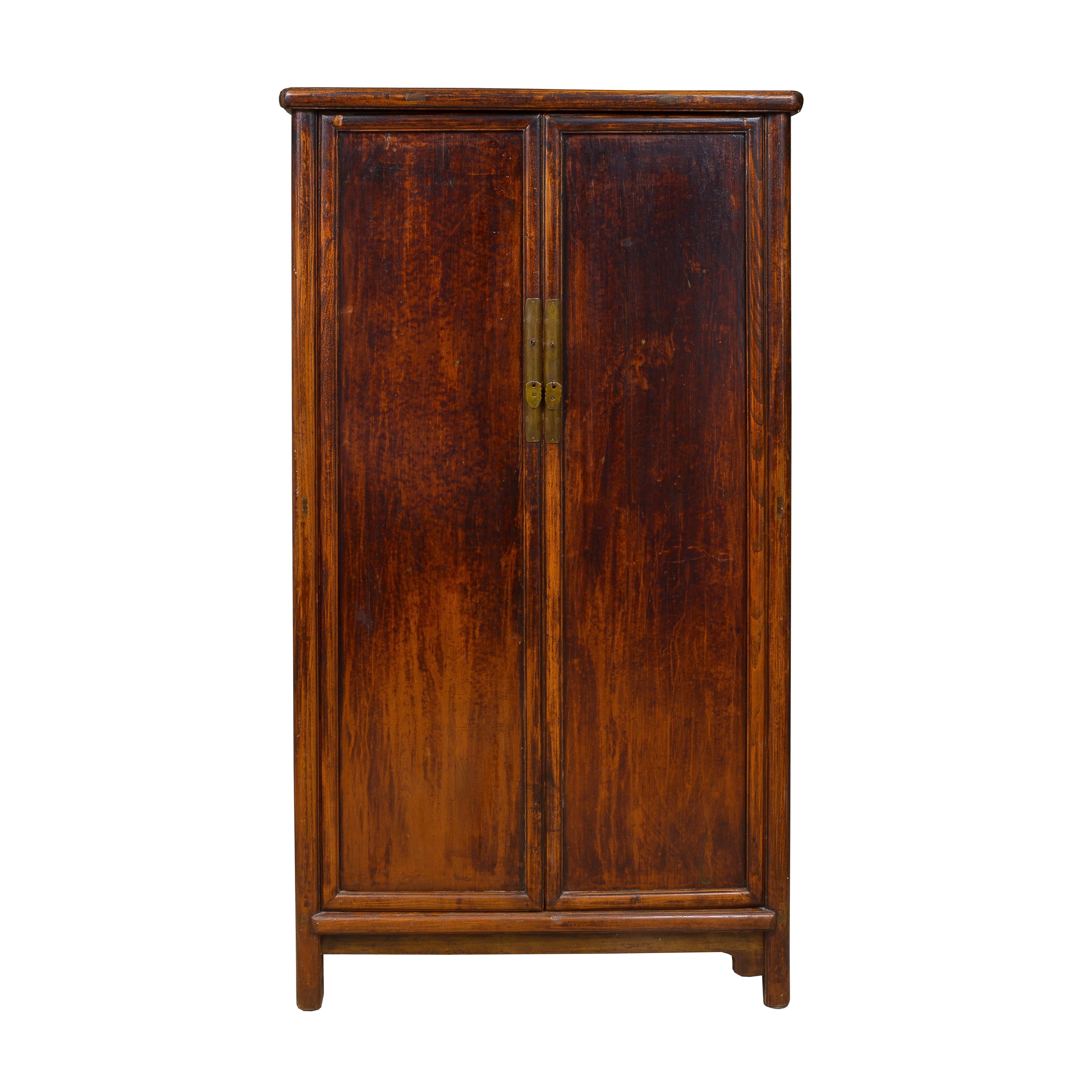 Tall armoire in Jumu wood with original red glaze with split storage and two middle drawers
Fitted with brass hardware
Pair of removable doors
Supported by high bracket feet