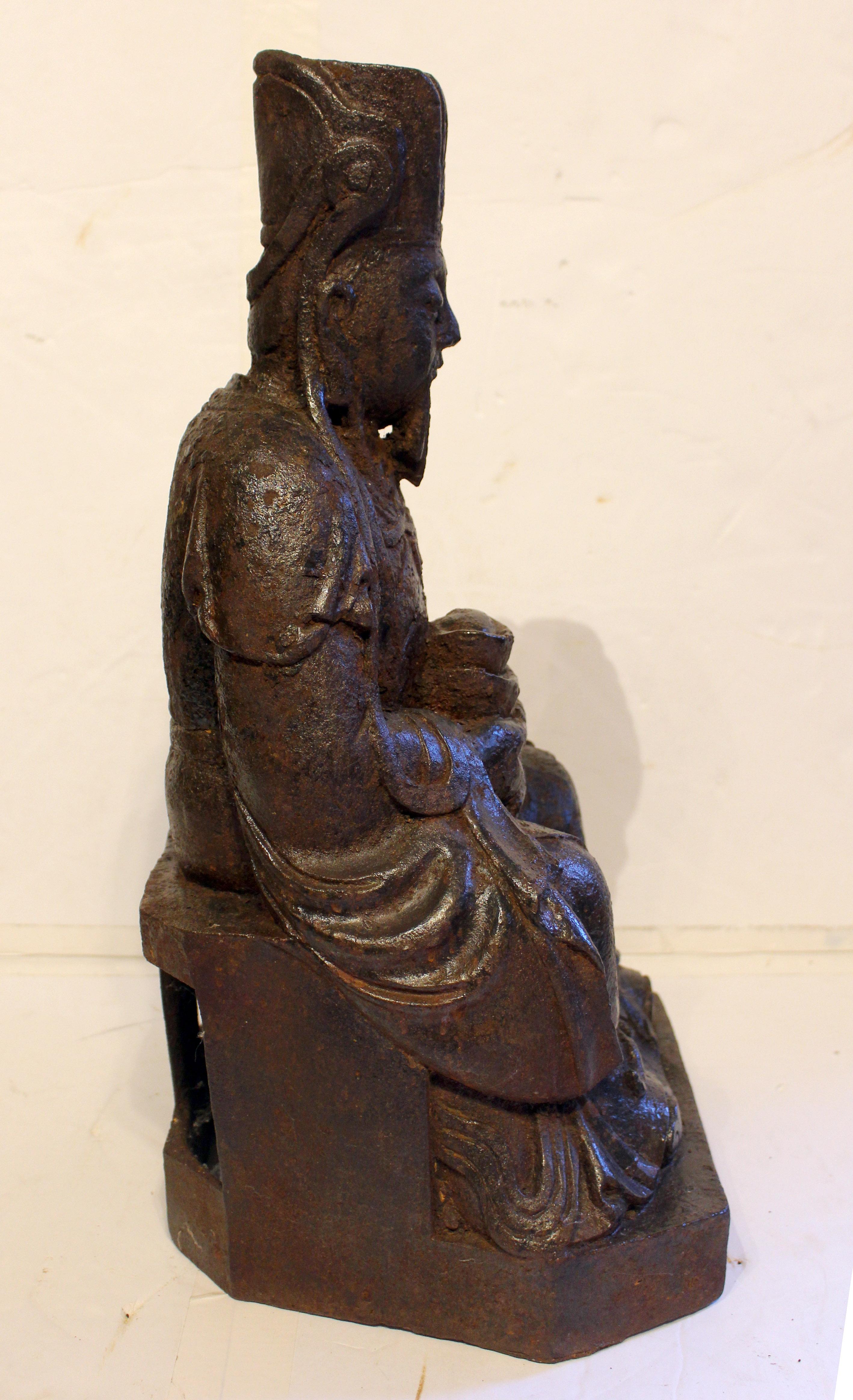 Mid-19th century Chinese cast iron seated figure. Chinese seated figure in official robes & head-dress, an immortal in Taoism & mythology. Probably Cao Guojiu, known for high moral principles & devotion to duty. With the integral stand, he no doubt