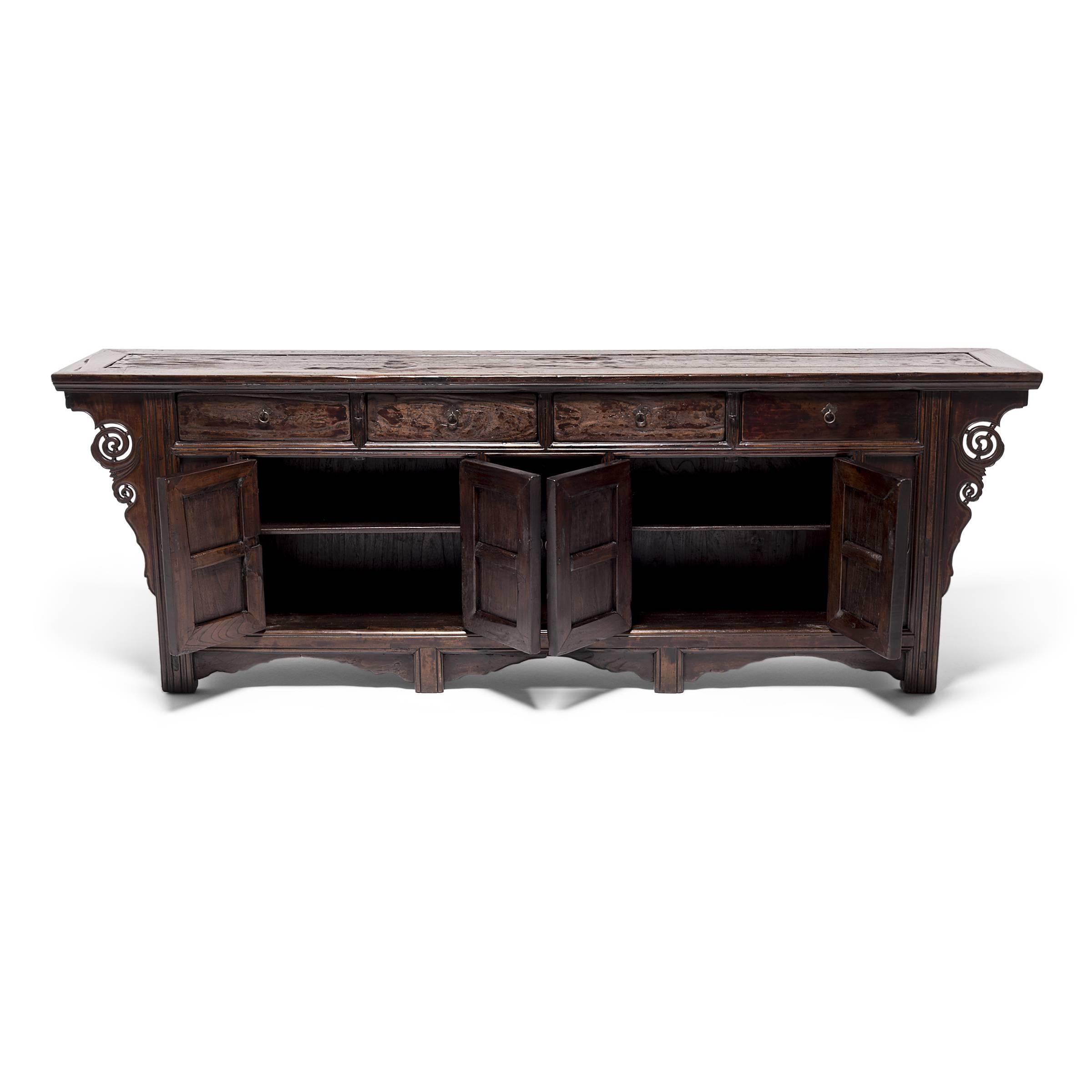 This stately coffer, sized to provide an ample amount of storage, was likely the centrepiece of a well-appointed home in the Shanxi province. A lustrous wax finish enhances the naturally open grain of this Qing-dynasty walnut cabinet, drawing out