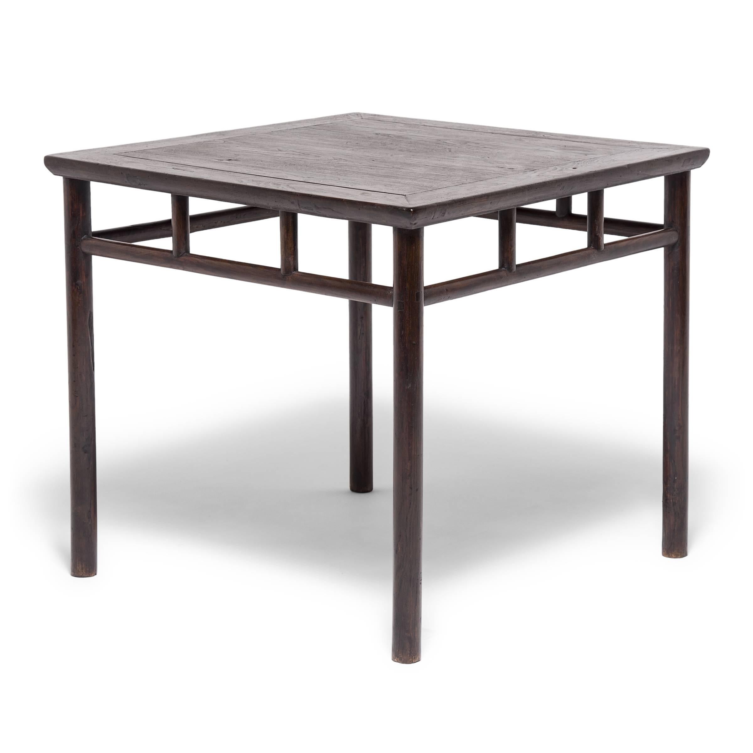 The subtle recessed position of the legs of this 19th century square table contributes to its refined proportions and allows the top to seemingly float. Closely related to architectural post-and-beam construction, the design of this table is in the