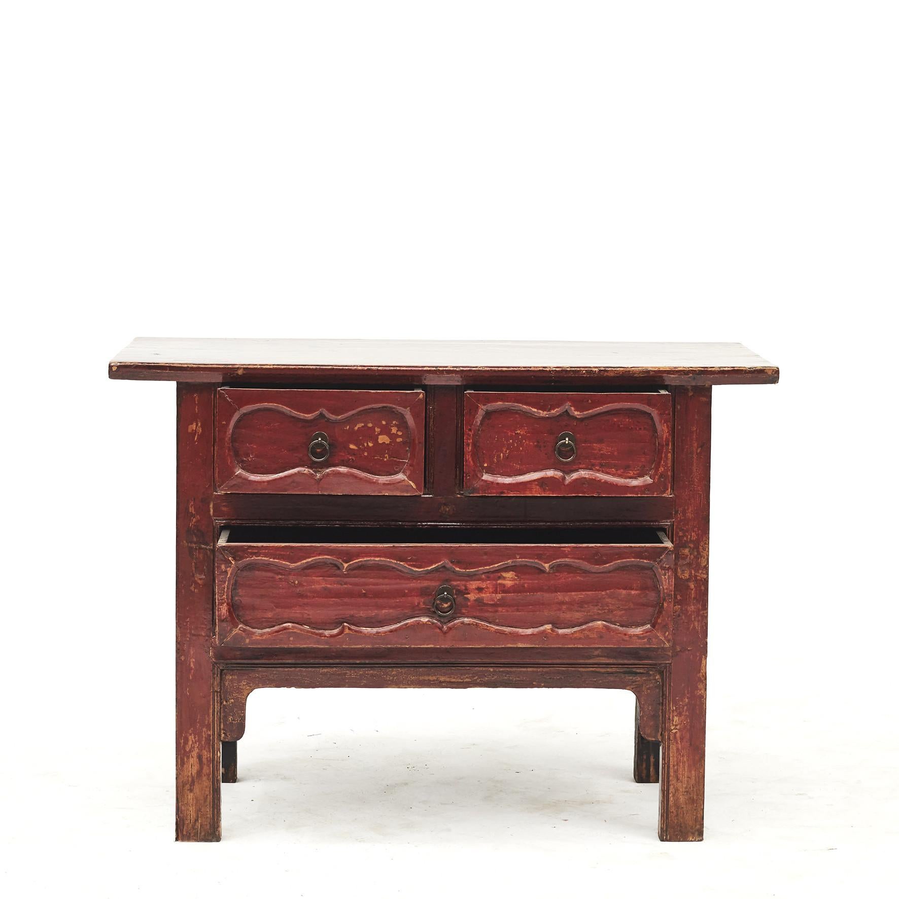 Mid-19th century chest of drawers or sideboard. Three drawers with carved details.
Original red lacquer and black lacquer on the sides, with a light clear surface finish, which highlights beautifully aged patina.
Shanxi, China, circa 1840.