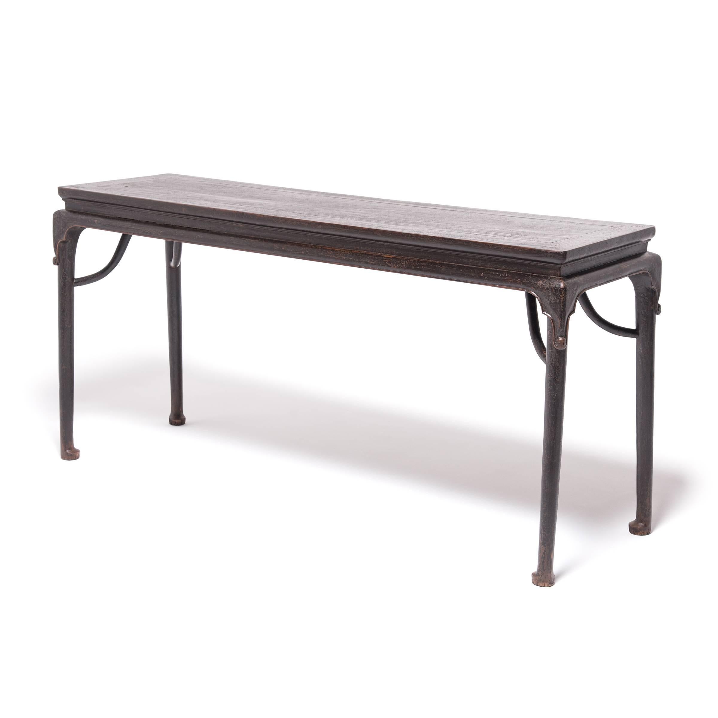 This streamlined design from the mid-19th century anticipates the clean-lined appeal of modernism with subtle curves that anchor it in the refined style of the Ming dynasty. Flowing lines emerge from the table’s waist forming slender legs with hoof