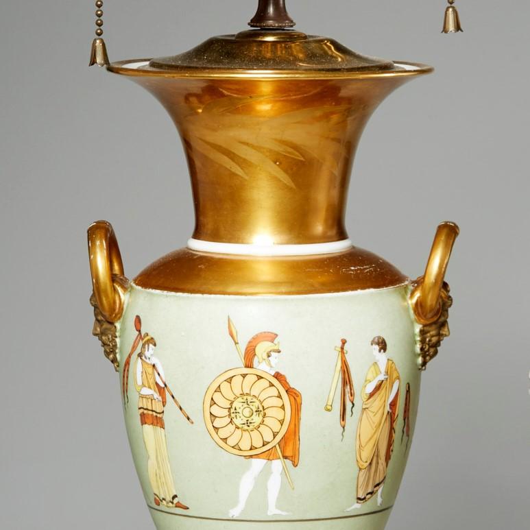 19th c. continental urn converted to a table lamp with gilt and polychrome enamel on porcelain, a painted wood base and a brass stem and socket. Despite having a chip to the stem of the vase. this lamp had great presence. It depicts beautifully