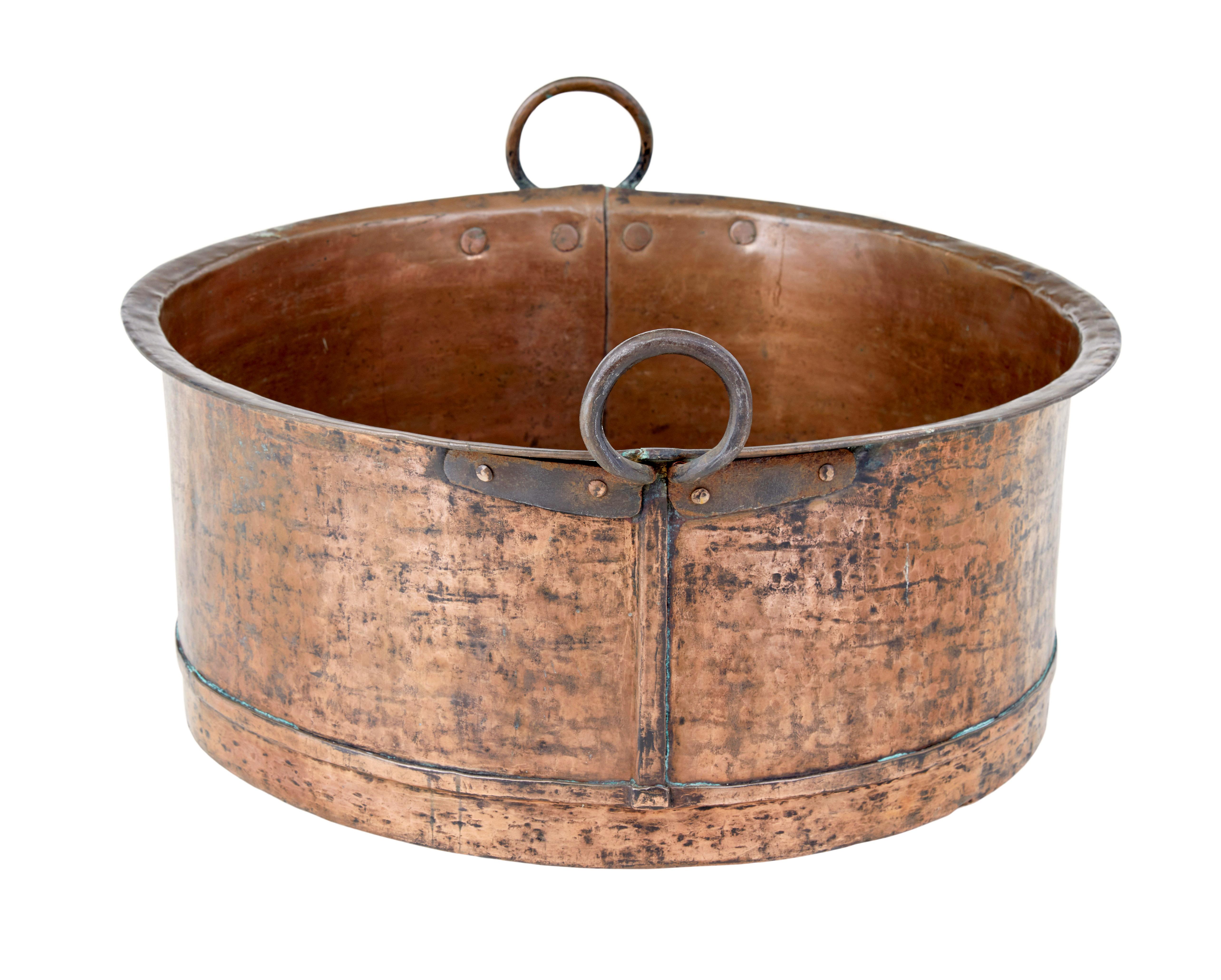 19th century copper cooking vessel circa 1846.

Good quality circular copper pot with rounded bottom.   Hand riveted iron work loop handles.  Fine original colour and patina.  Date stamped on the side.

Ideal for use today as a log bin or for