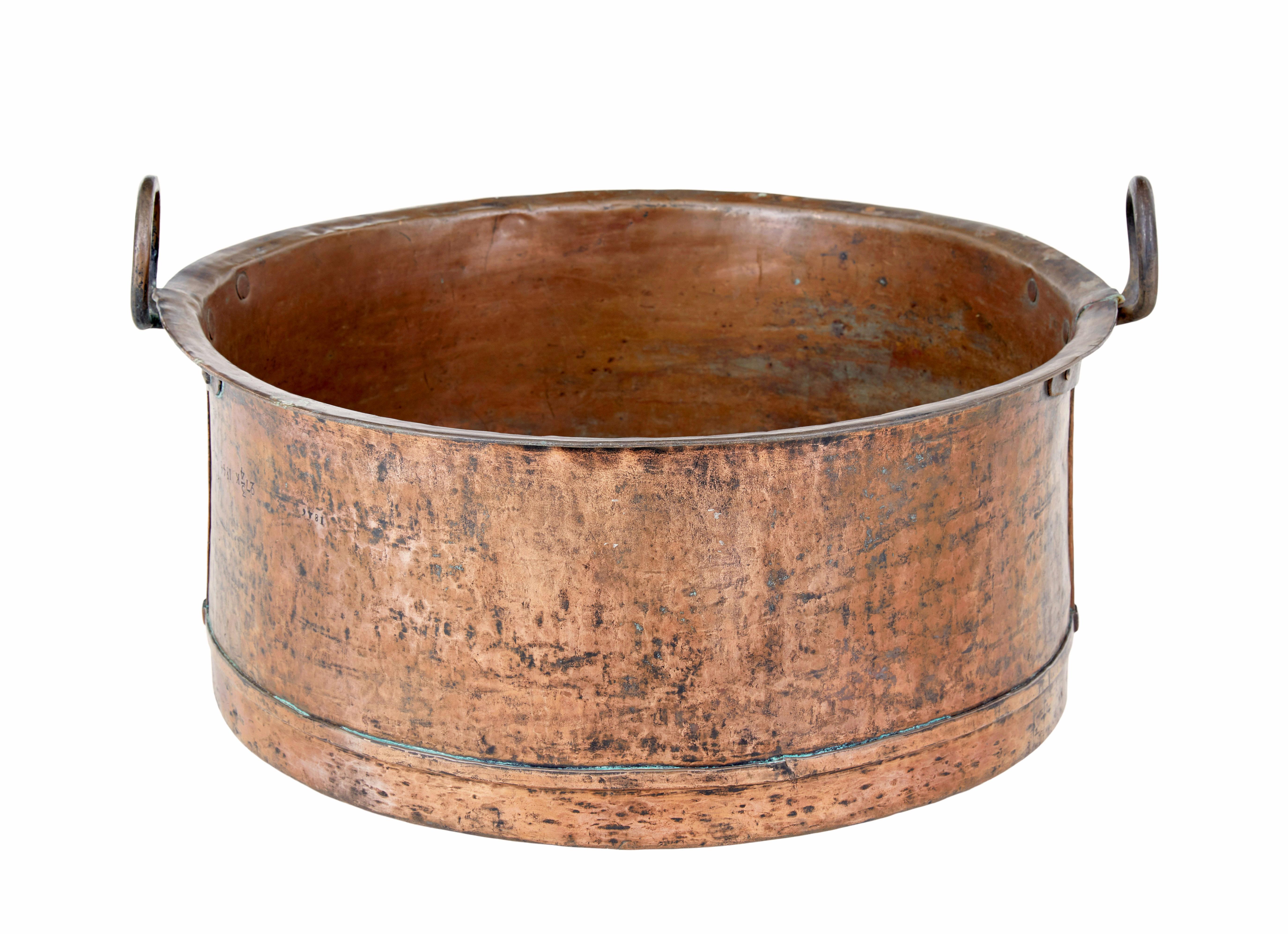 19th century copper cooking vessel circa 1846.

Good quality circular copper pot with rounded bottom.   Hand riveted iron work loop handles.  Fine original colour and patina.  Date stamped on the side.

Ideal for use today as a log bin or for