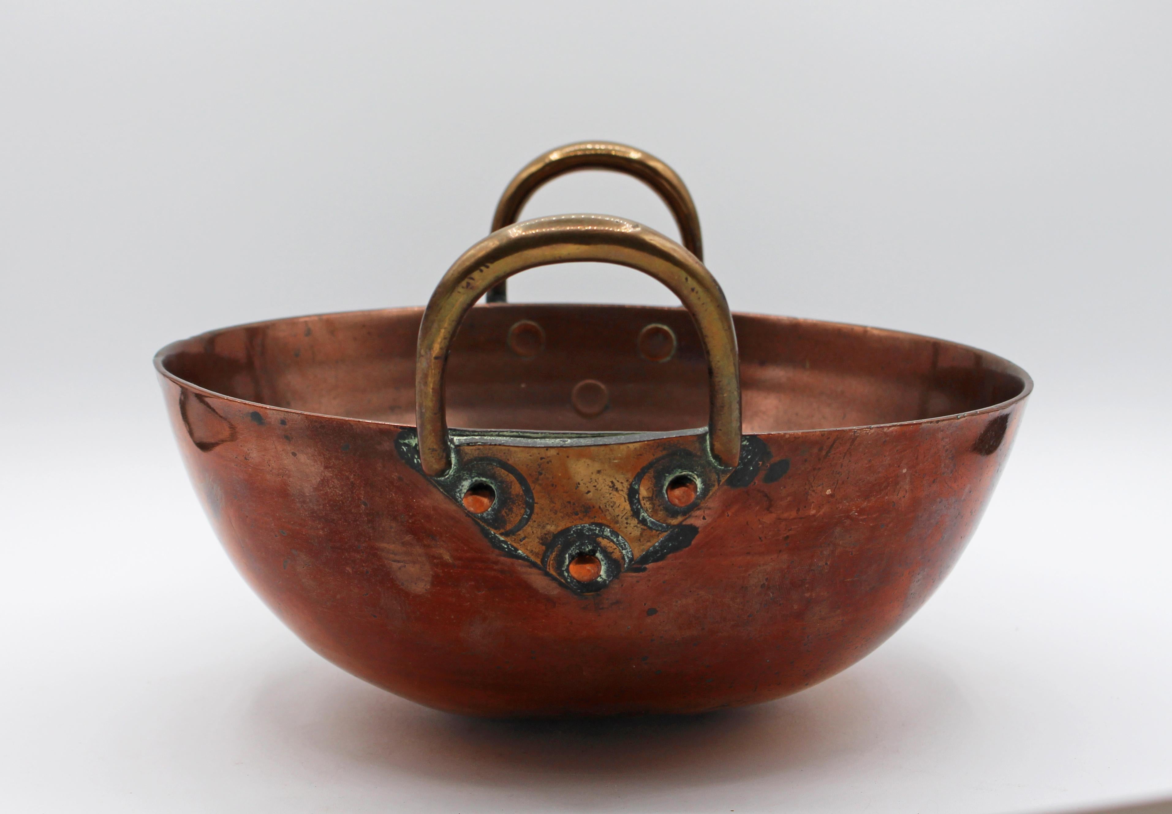 Mid-19th century copper mixing bowl with 2 triple rivet handles, one slightly bent. Well used & rare hefty weight.

Measures: 11.5