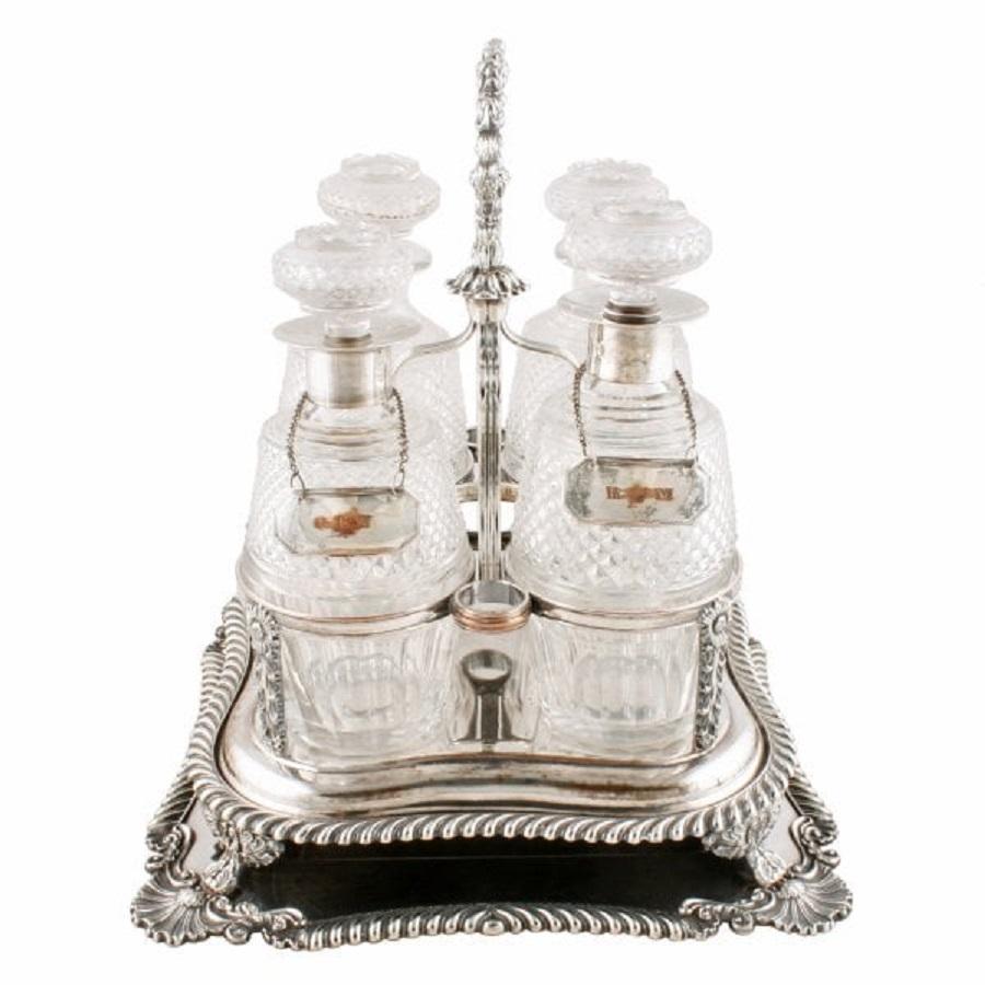 A middle of the 19th century silver plated decanter stand and matching tray.

The stand rests on the silver plated tray that has a manufacturer's mark for Boardman & Glossop of Sheffield.

The square stand holds four cut crystal decanters, has a