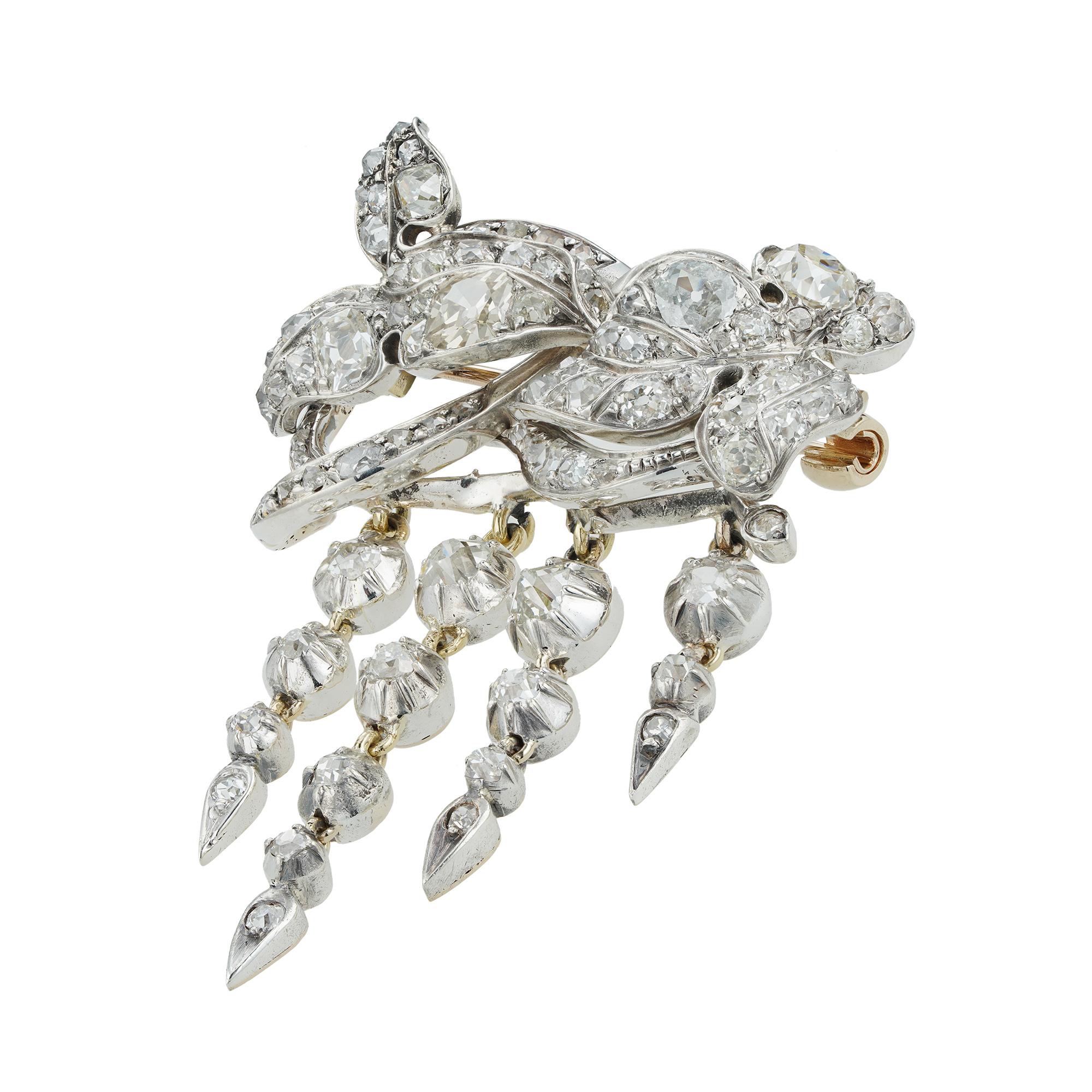 A mid-19th Century diamond brooch, designed as a miniature corsage ornament, with entwined scrolled leaves, suspending four foliate drops, all set throughout with old brilliant- and oval mixed-cut diamonds, estimated to weigh a total of 4.5 carats,