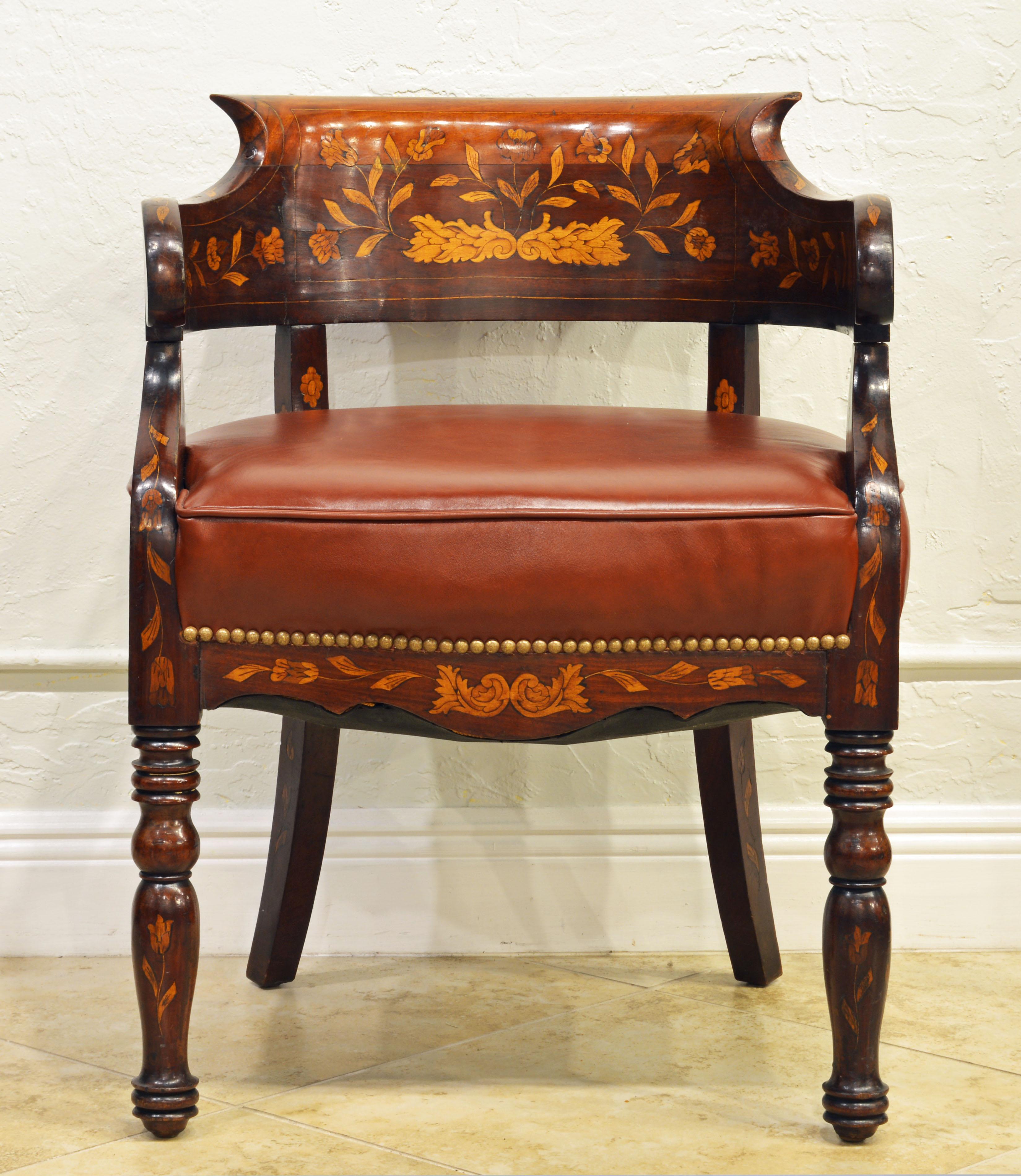 The generous detailed inlays with flowers, leaf work and even a lion head mask make this chair one of a kind. The seat is well upholstered and covered with brass nailhead trimmed glove quality leather. It is comfortable for lounging and especially