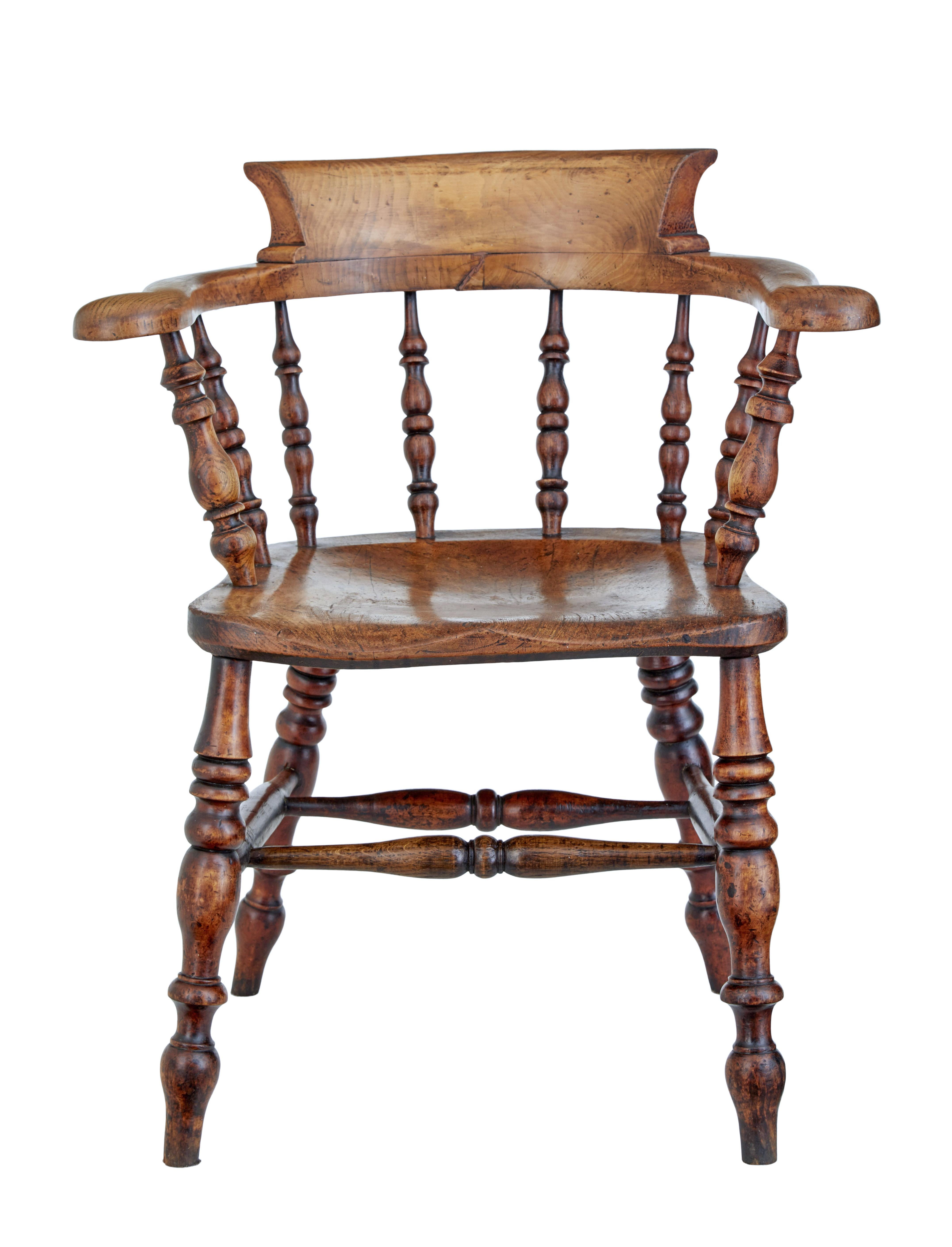 Mid-19th century elm captains armchair, circa 1860.

Good quality character armchair made from solid elm. Shaped back and arm linked with turned spindles to the seat. Turned legs united by stretcher.

Obvious surface marks and natural movement