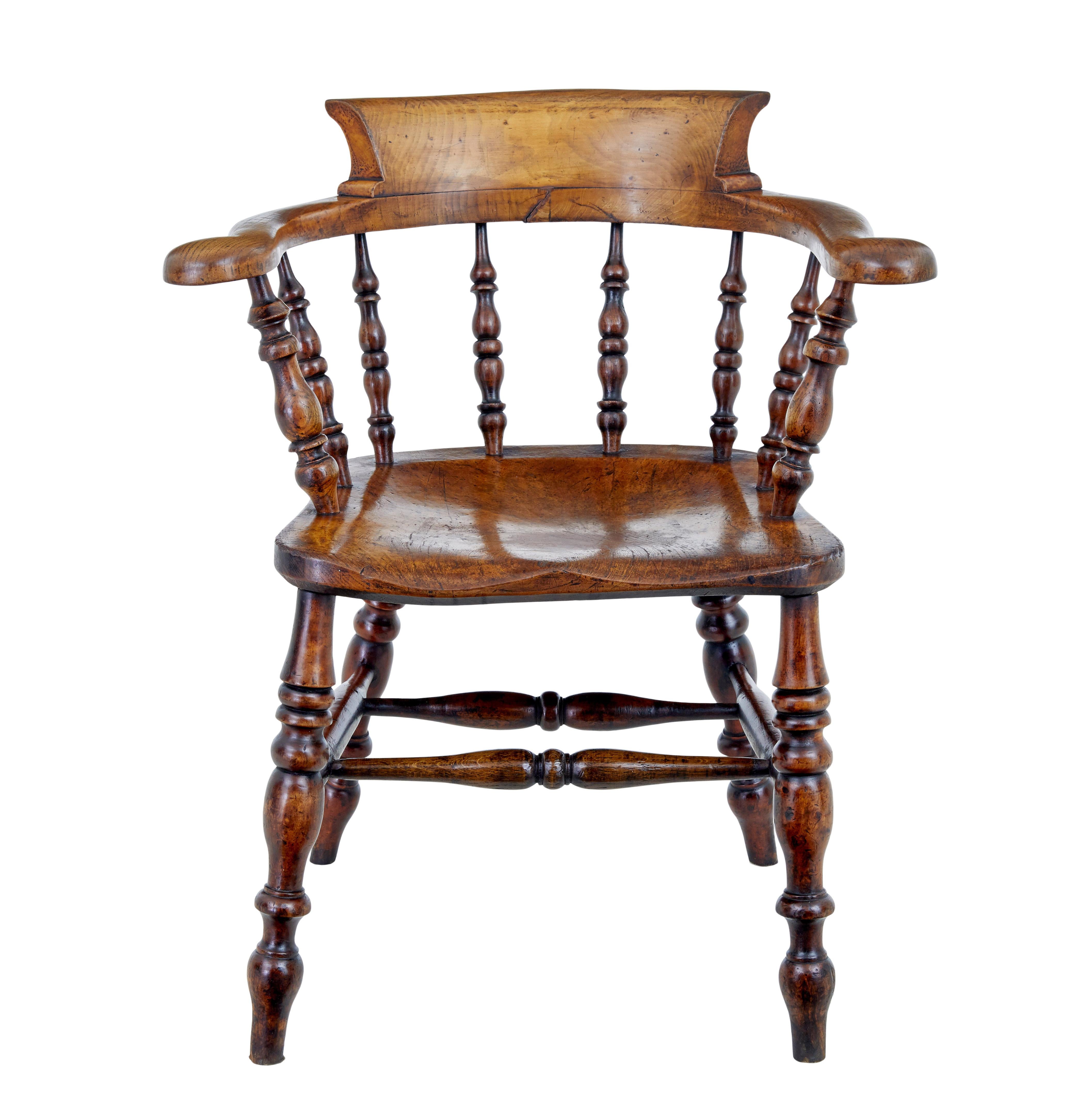 Mid 19th century elm captains armchair circa 1860.

Good quality character armchair made from solid elm.  Shaped back and arm linked with turned spindles to the seat.  Turned legs united by stretcher.

Obvious surface marks and natural movement to