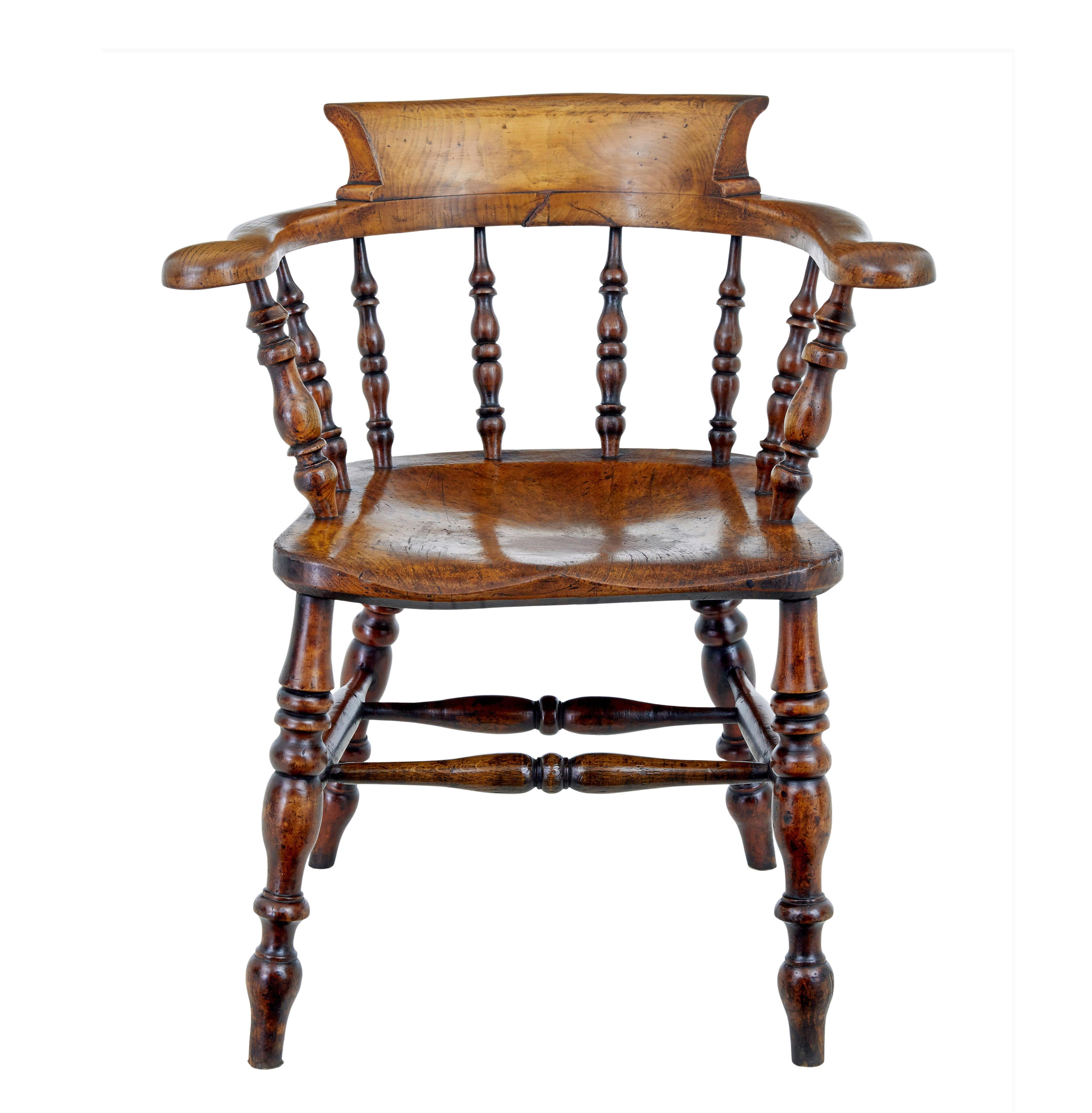 Mid 19th century elm captains armchair circa 1860.

Good quality character armchair made from solid elm.  Shaped back and arm linked with turned spindles to the seat.  Turned legs united by stretcher.

Obvious surface marks and natural movement to