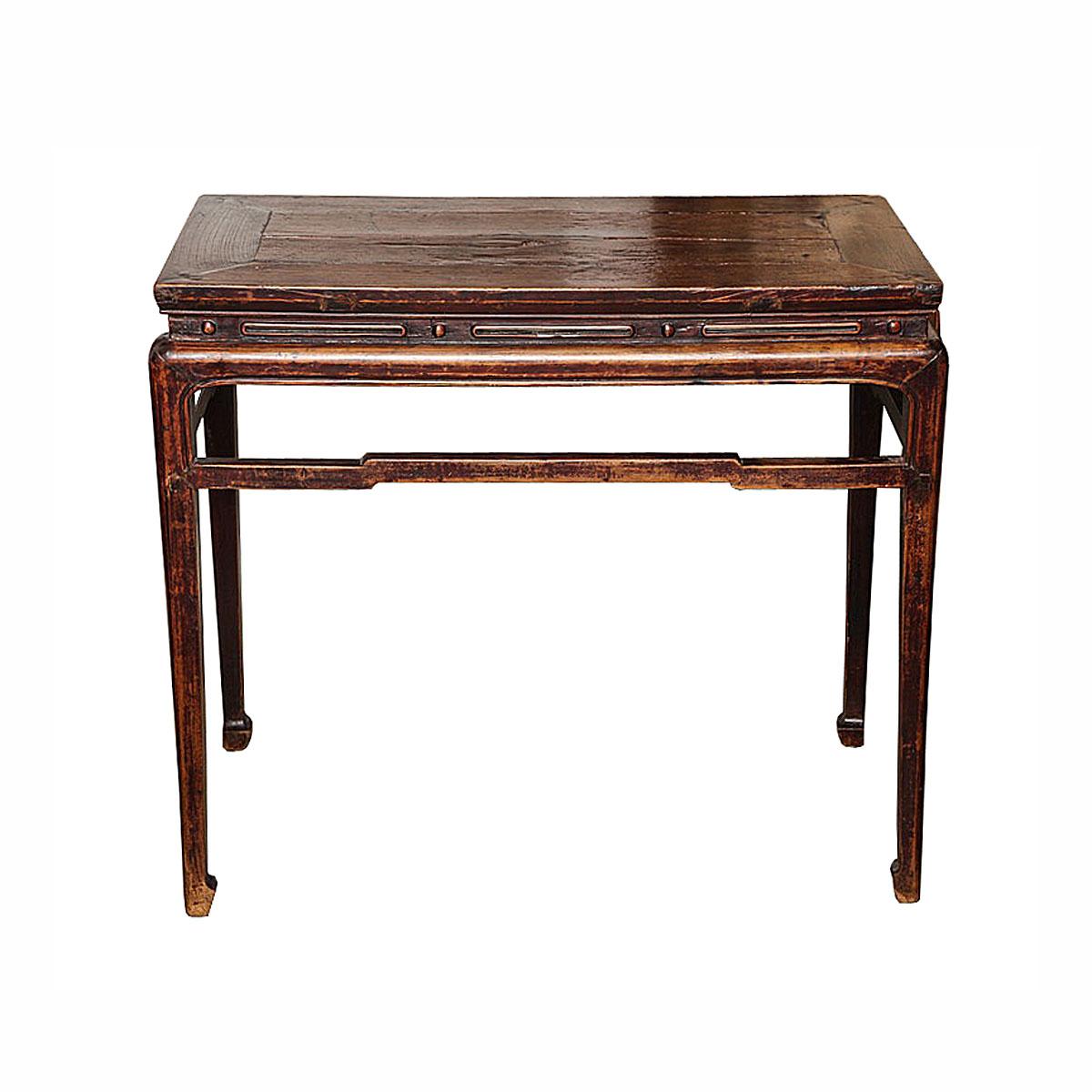 A Northern elm wood console table with high stretchers and long cornered legs, from China, circa 1860. This table displays the features of traditional Asian carpentry where no nails or screws are used, but a complex wood joint system. While showing