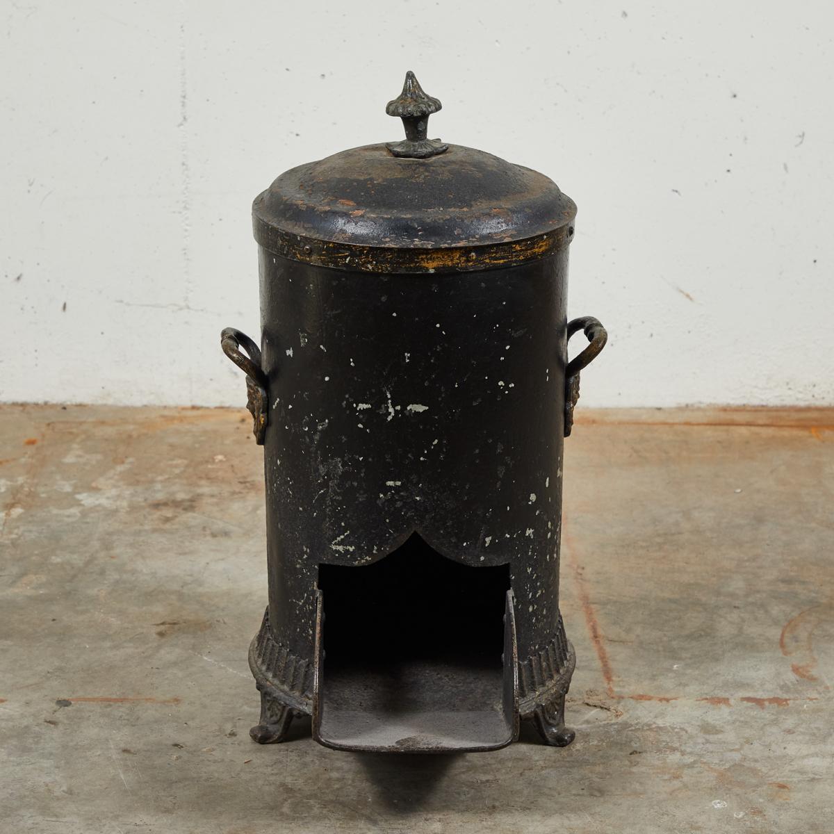 Mid 19th-century English coal scuttle. Originally used to store coal near the fireplace for immediate access, this could still be used in the same way today. The black painted tin siding has an aged patina due to the object's history of use.