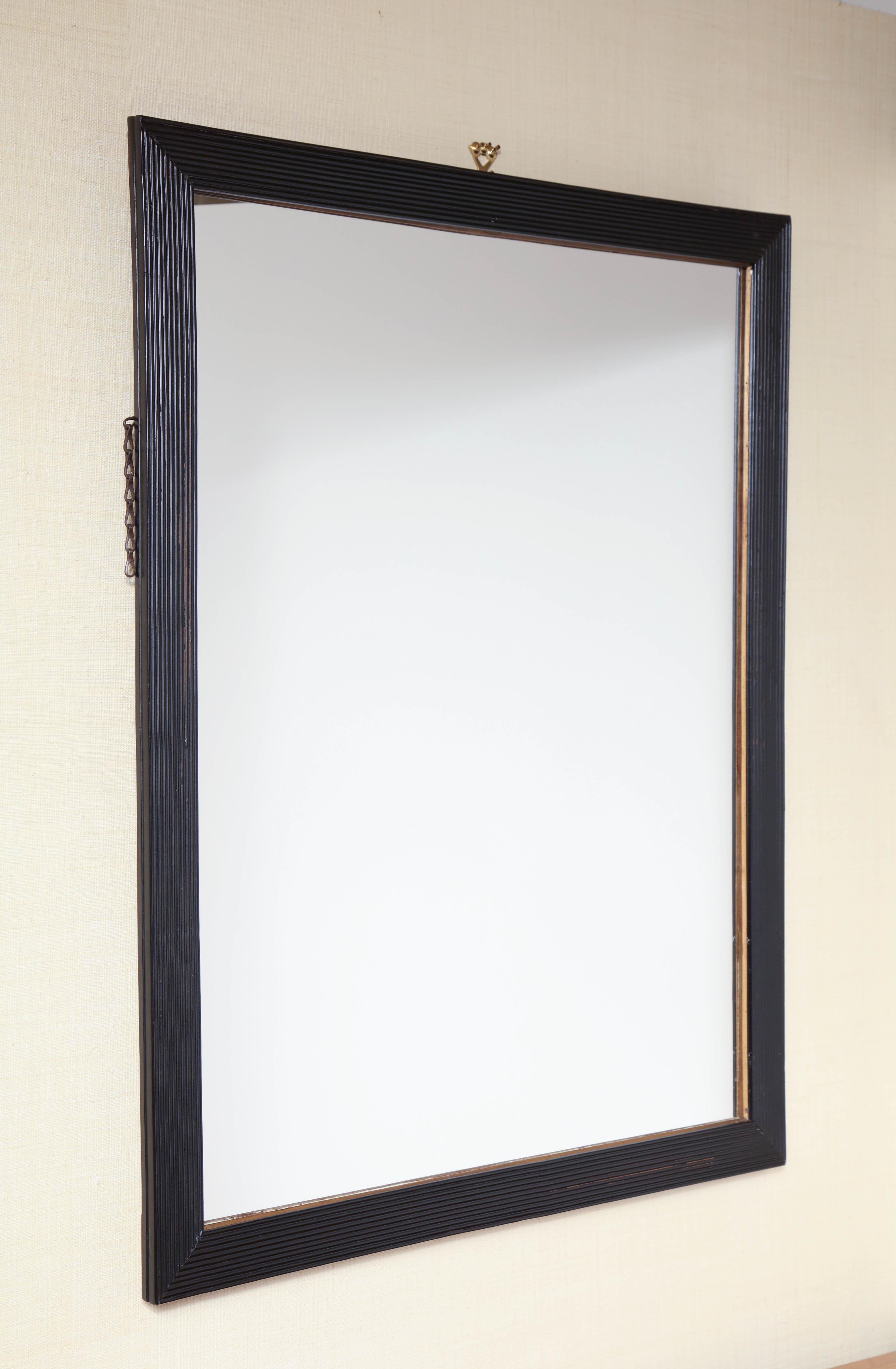 Mid-19th century English, ribbed frame black lacquer mirror.