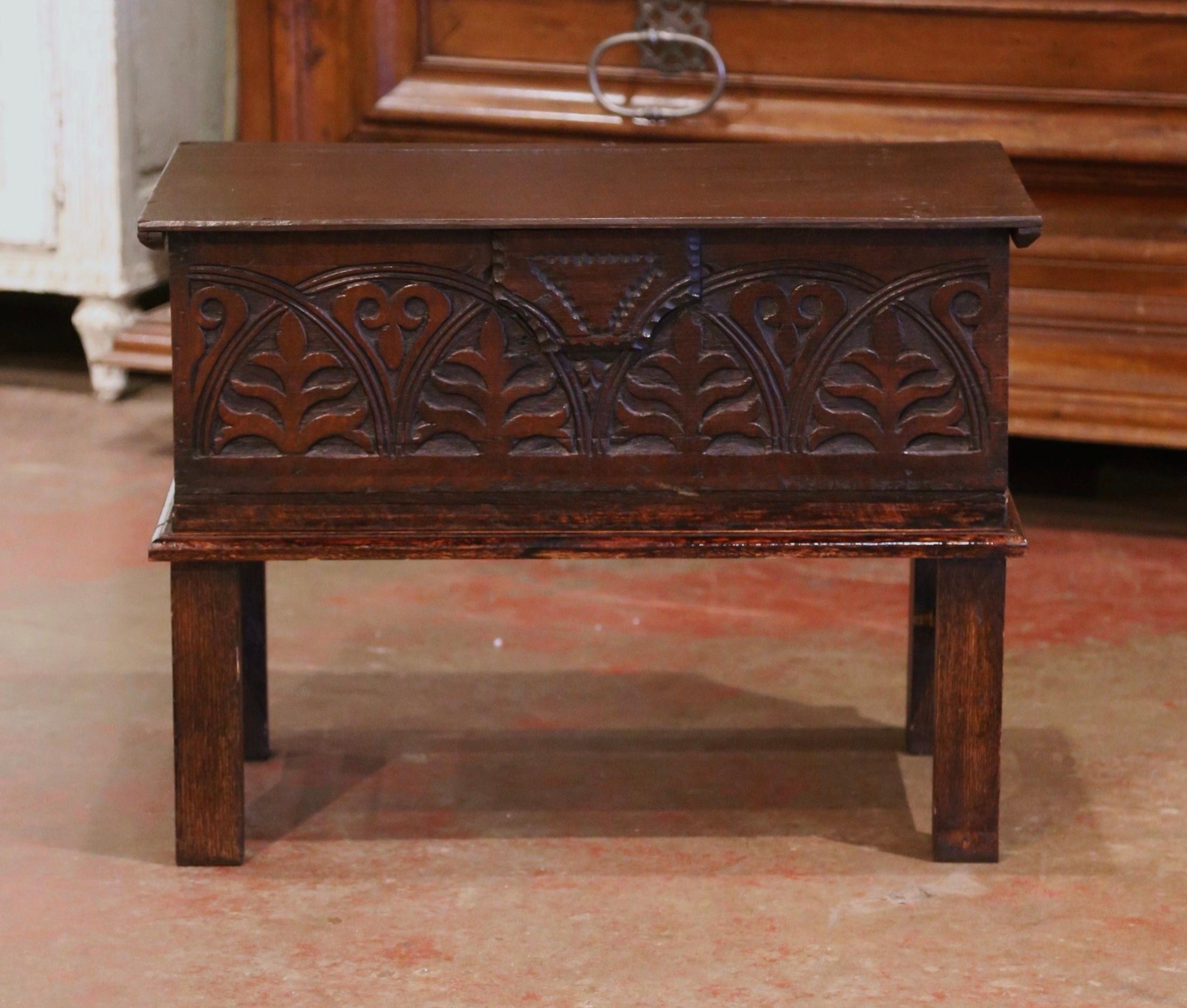 This Classic, antique bible box was carved in England circa 1860. The sturdy, Baroque style trunk, standing on a wooden base, features deep floral decor carvings on the front. The trunk opens from the top to reveal an inside storage compartment, and
