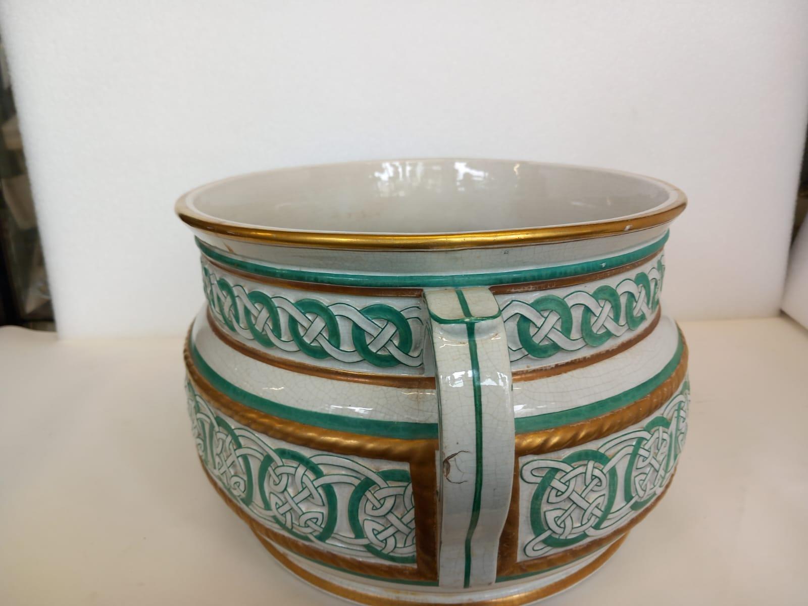 An English 2 handled foot bath with Celtic knots design, in green with bands of gilding. Probably Staffordshire
