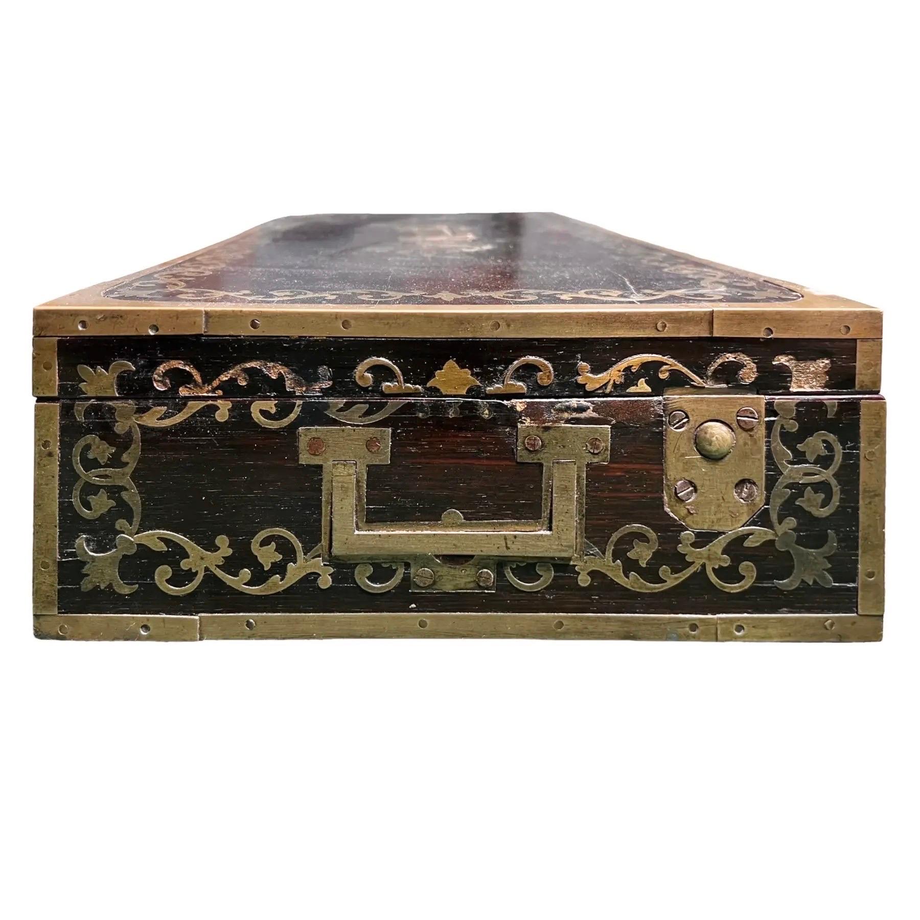 An English gentleman’s traveling chest circa 1860, made by J.Braman. Framed in brass with ornate brass floral inlay. The interior is lined with red velvet and red leather with gilt tooling.