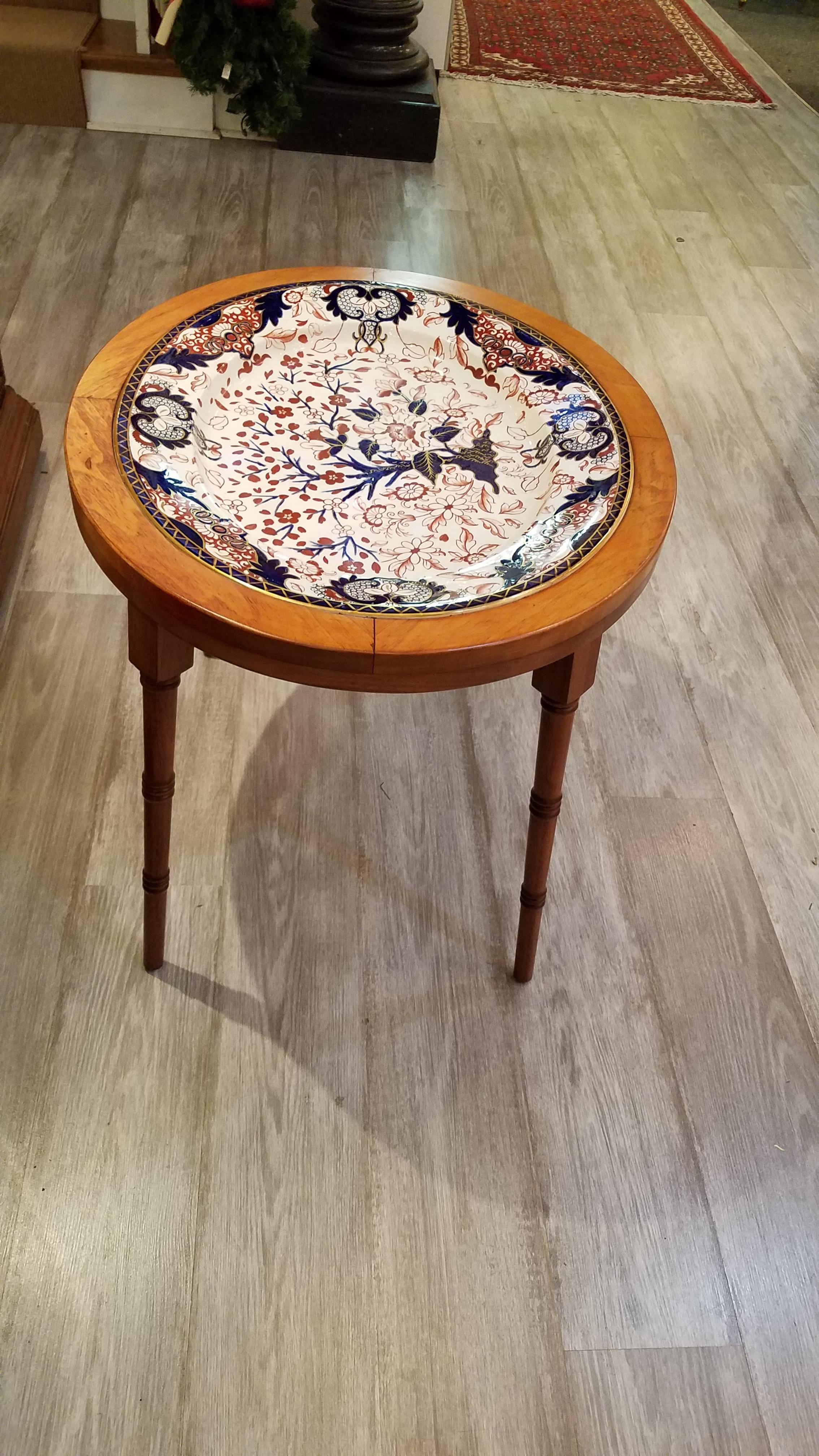 Large English hand painted ironstone platter in an Imari pattern in cobalt, iron red and white with a Regency style faux bamboo base in a medium finished maple. Great size for a smaller coffee or cocktail table.