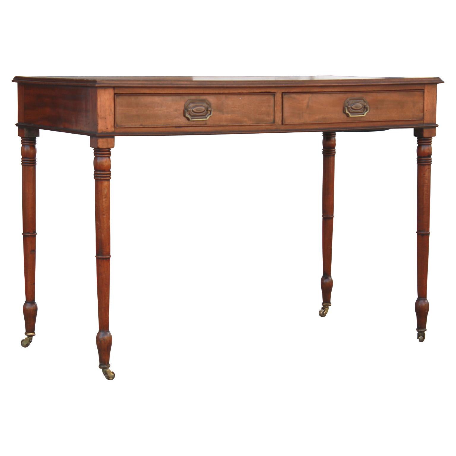 Gorgeous mid-19th century English leather top writing desk, William IV style. Features two drawers. The original hardware believed to have been replaced.