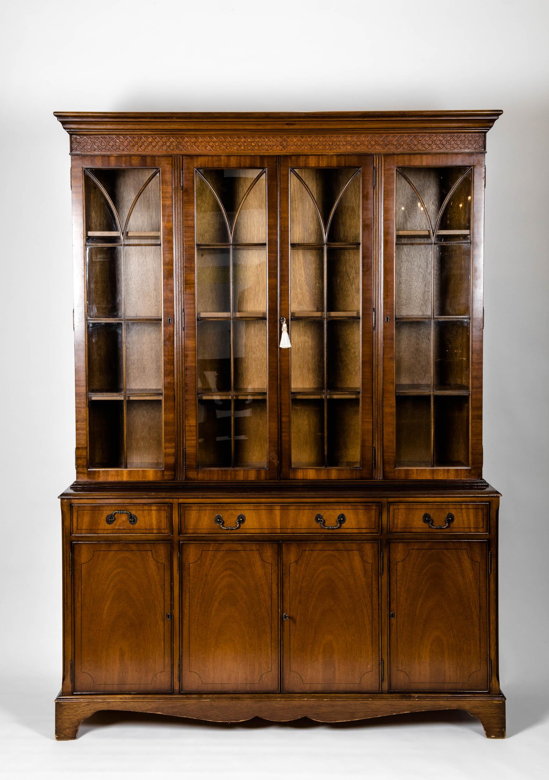 Mid-19th century English mahogany wood china cabinet / Hutch with exterior design details. The hutch / china cabinet is in excellent antique condition. Minor wear consistent with age / use. Stamped and mark in the back. The cabinet stand about 82