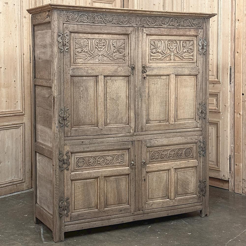 Mid-19th Century English Oak Wardrobe in Stripped Oak is an interesting design, with a two tiered effect only really noticeable when the doors are opened ~ two above and two below.  A tailored crown molding appears over the bonnet which has been