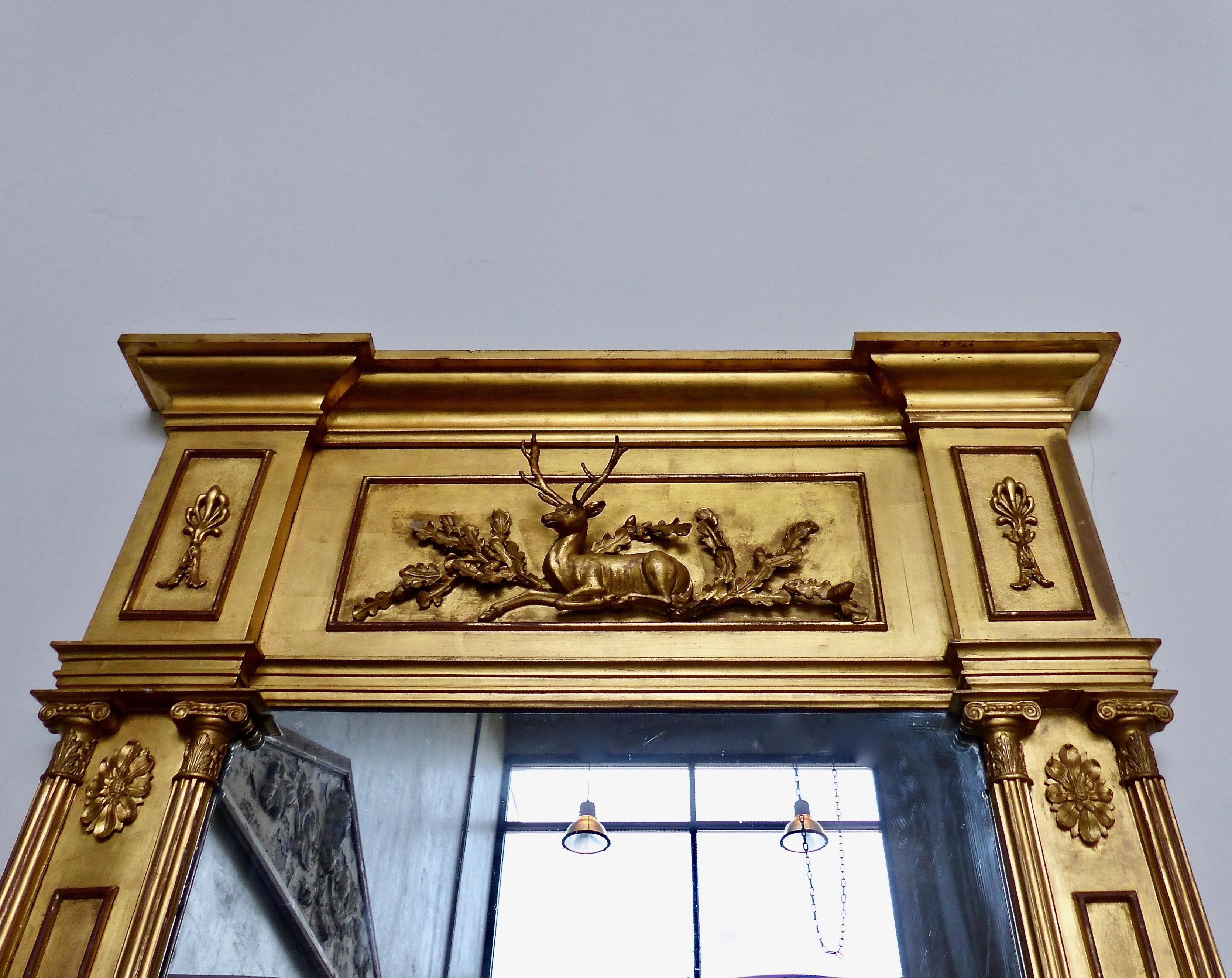 A stately English mantel mirror featuring a hand carved deer as its centerpiece. Original gold leaf over wood from circa 1850. Classic column and pediment details. An excellent example of the best workmanship of its era.
Dimensions: 76 H” x 44 W” x