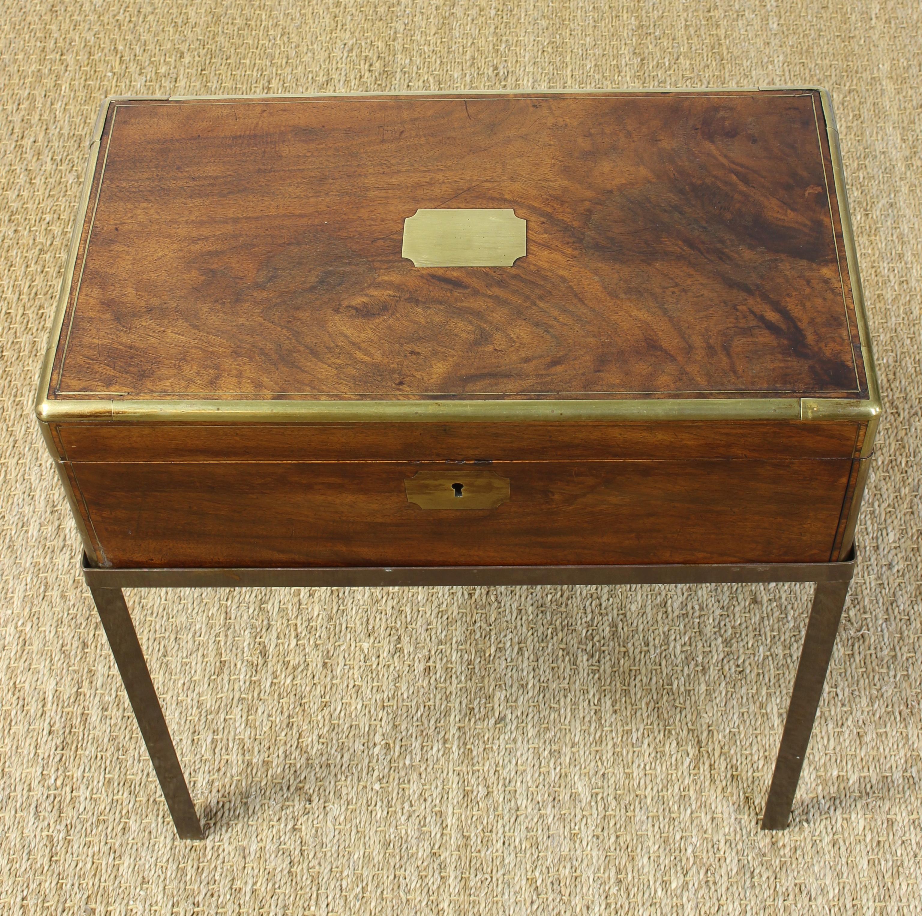 An elegant mid-19th century English brass bound mahogany writing box or lap desk on later custom-made brass stand.